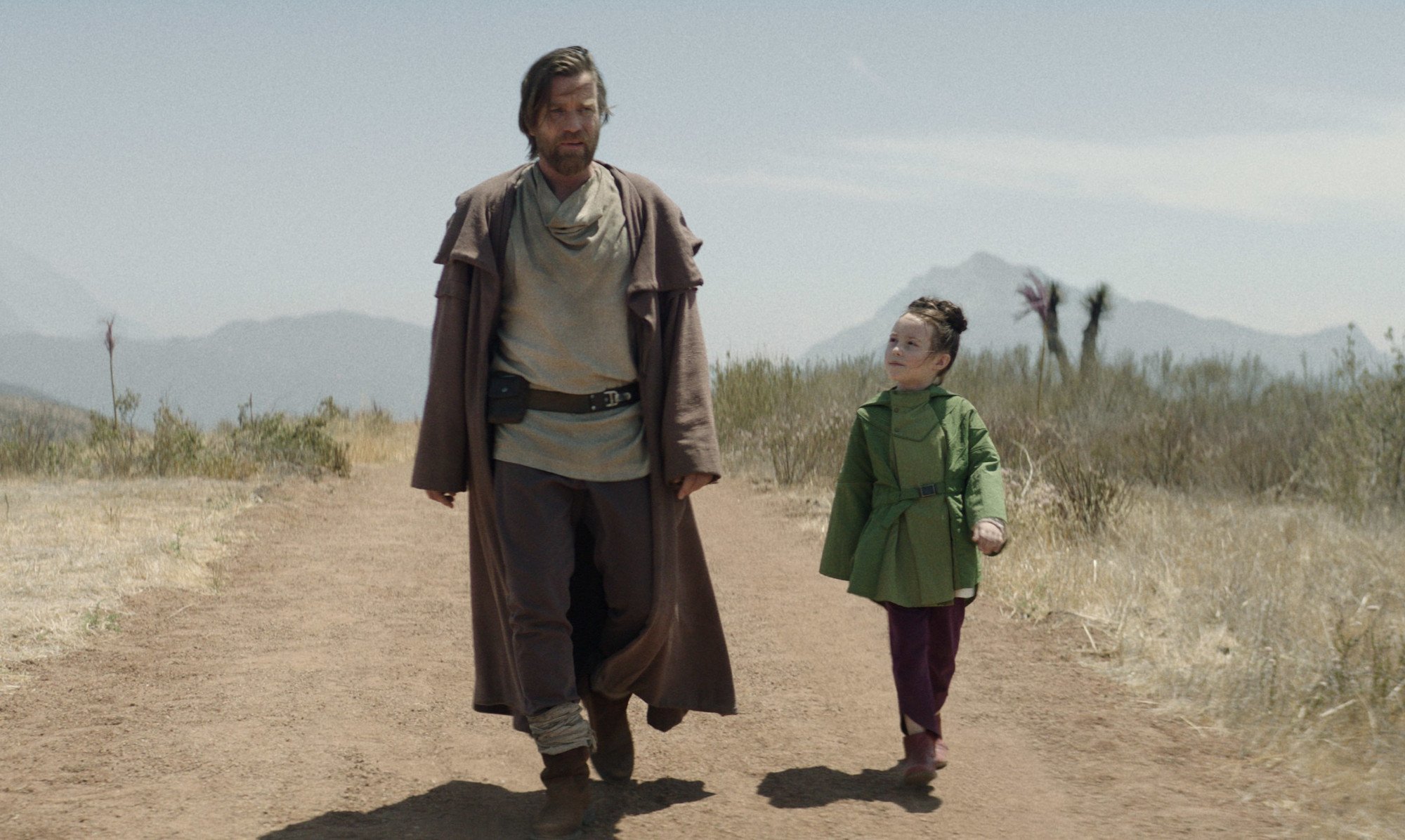 Ewan McGregor and Vivien Lyra Blair as Obi-Wan and Leia in 'Obi-Wan Kenobi,' which hasn't been confirmed for season 2. The two are walking in the desert, and Leia is looking up at him.