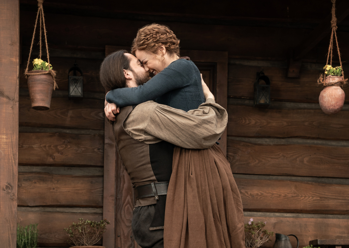 Outlander season 6 Richard Rankin and Sophie Skelton embrace as Robert and Brianna in an official image