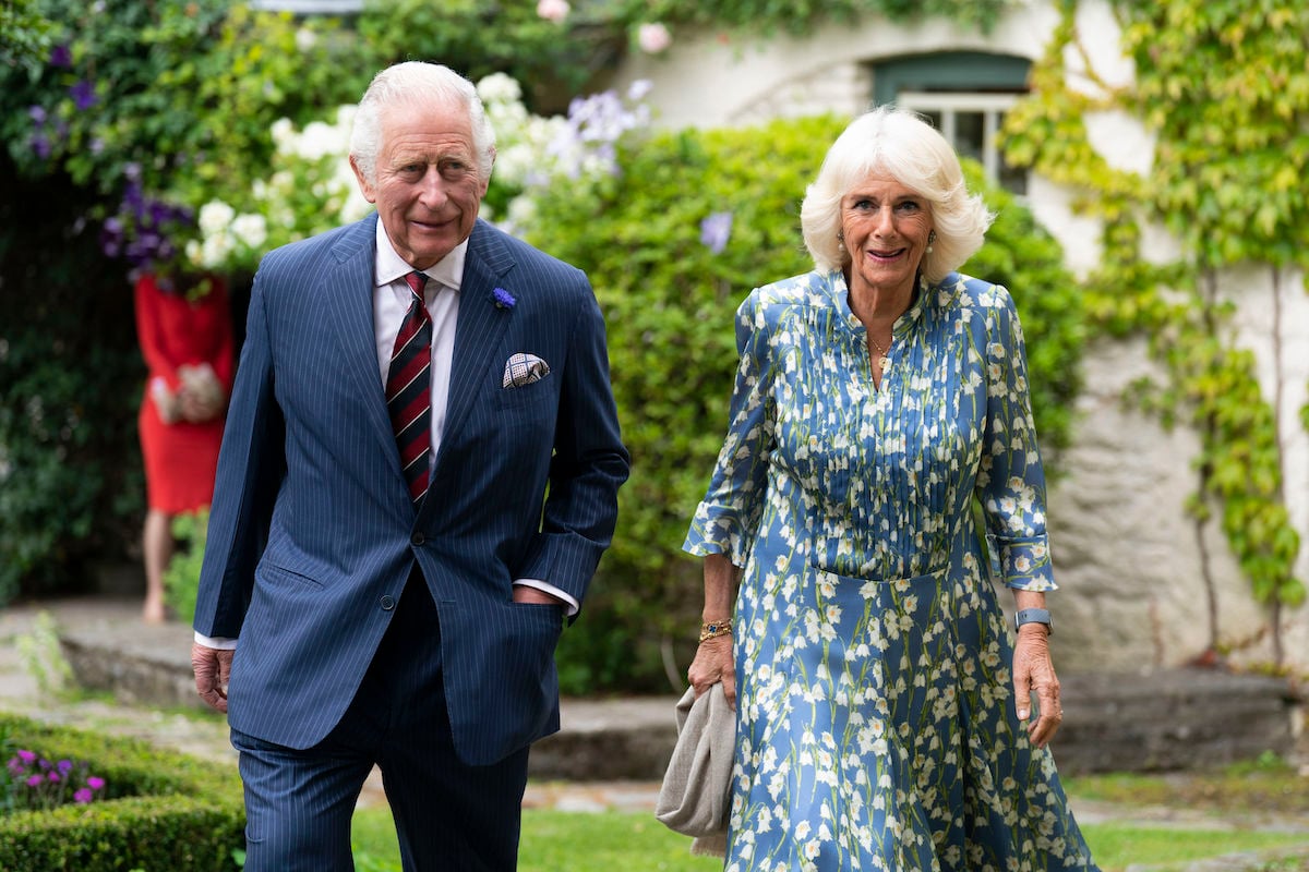 Prince Charles and Camilla Parker Bowles, who said she and Prince Charles like to read when they travel, walks next to Prince Charles