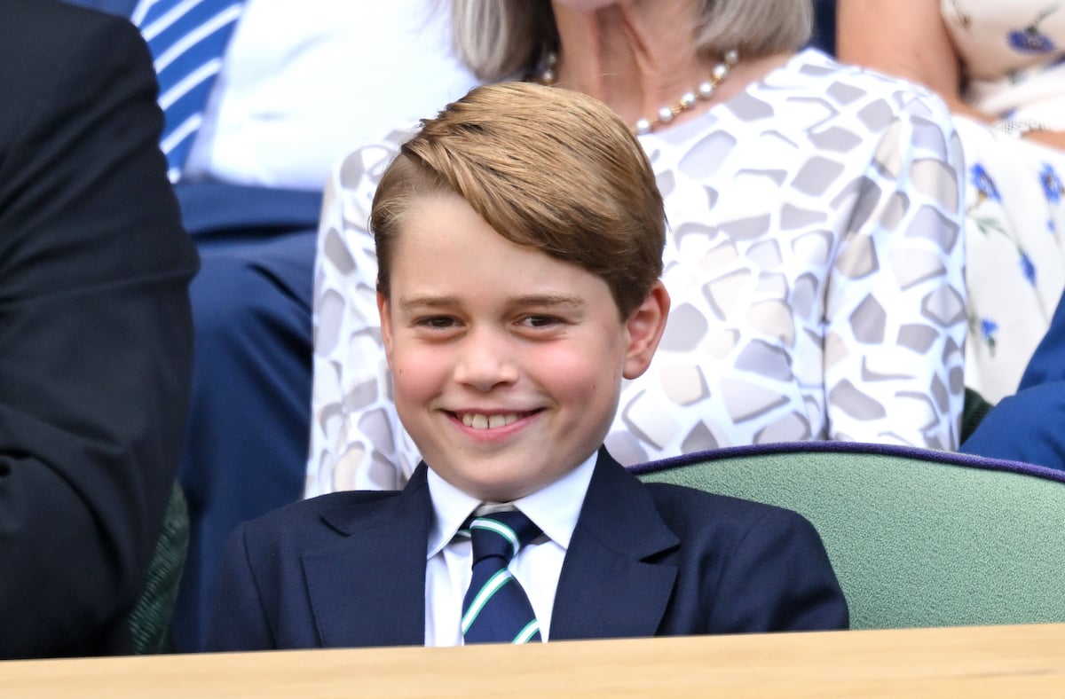 Prince George, who reportedly told a dog walker his name was Archie, smiles wearing a suit and tie