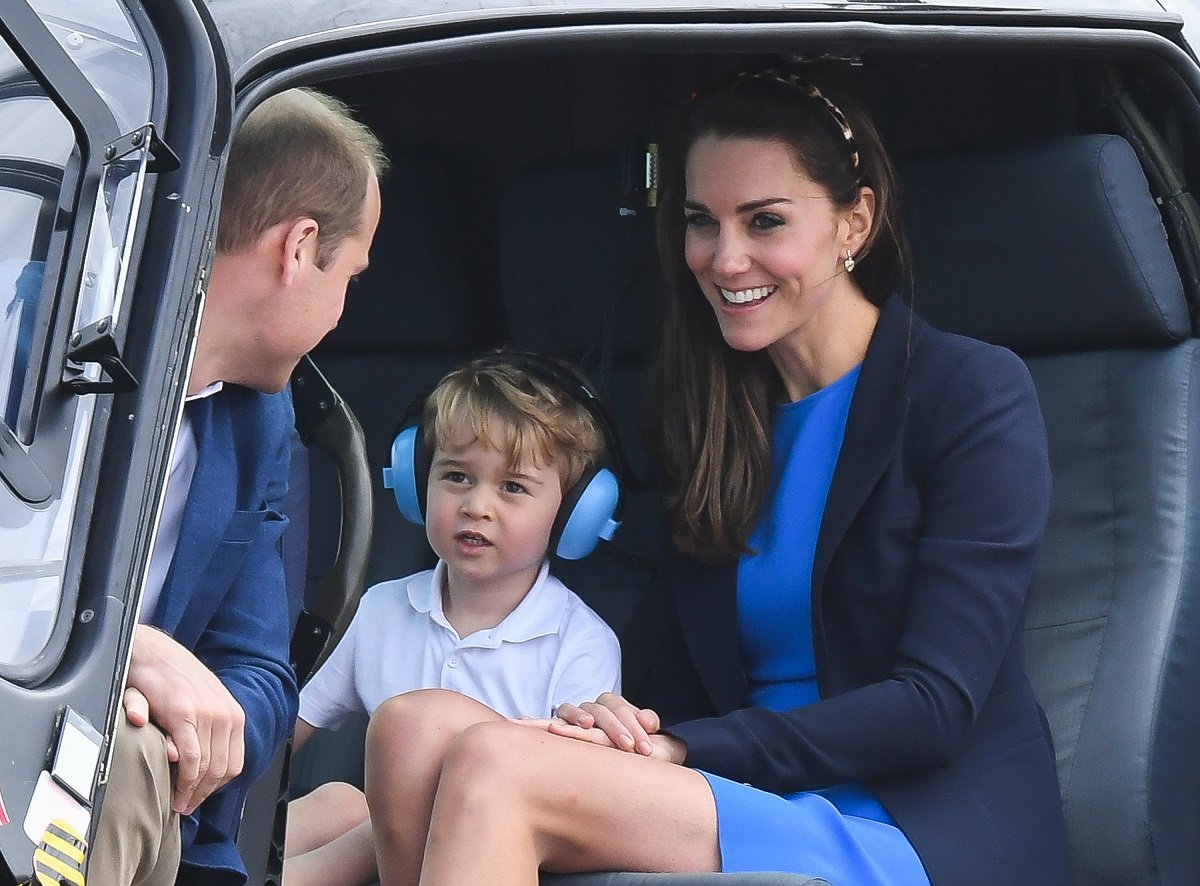 Prince George sitting in a helicopter with his parents at The Royal International Air Tattoo