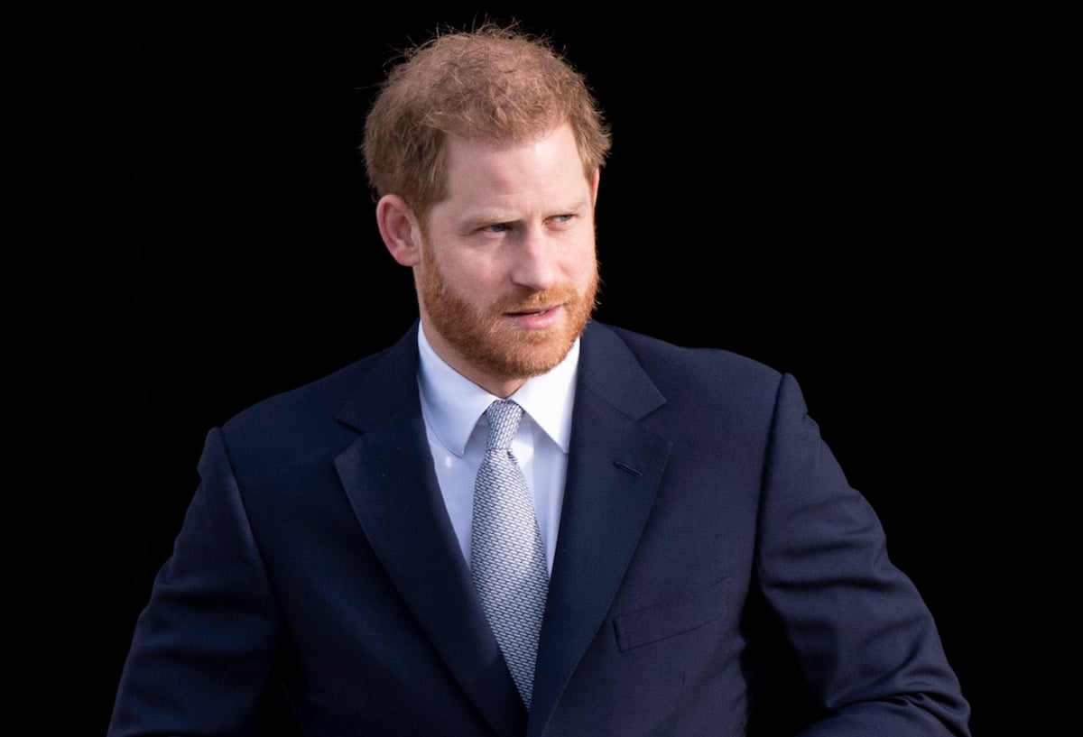 Prince Harry looking to the side and wearing a suit
