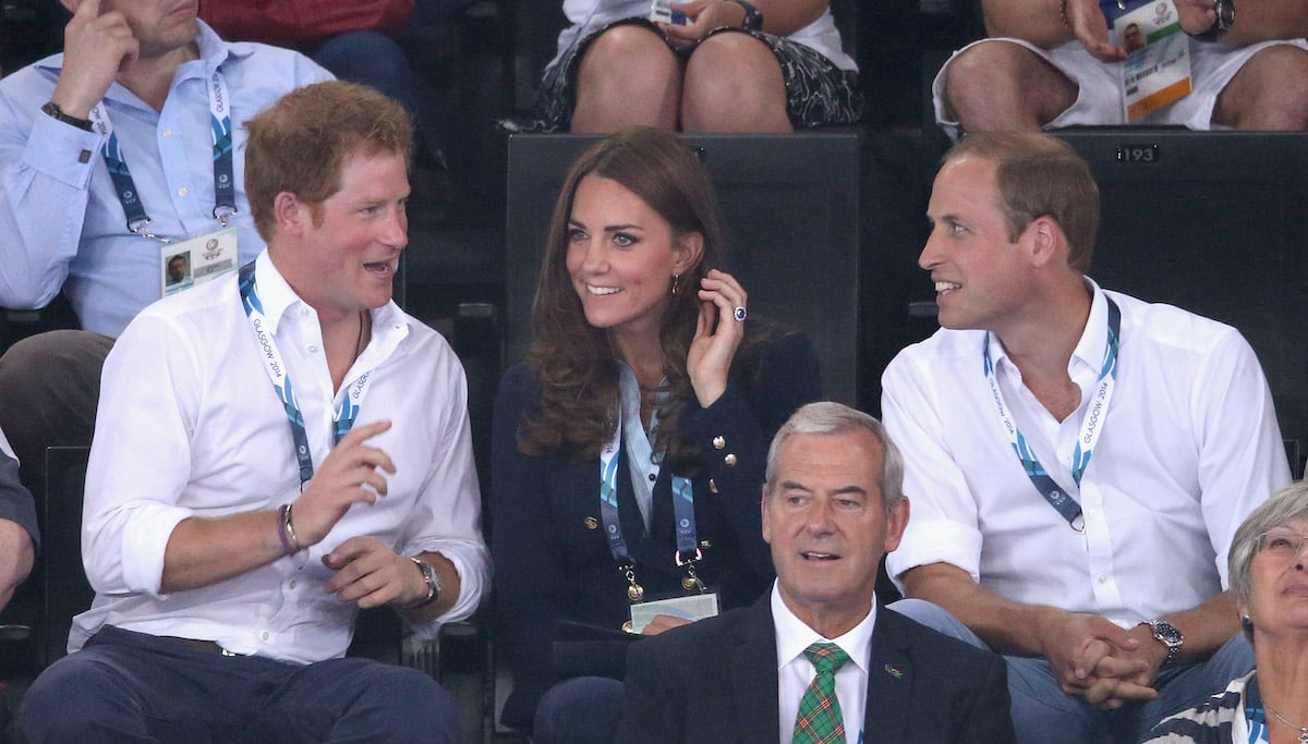 Prince Harry sits next to Kate Middleton and Prince William at the 2014 Commonwealth Games