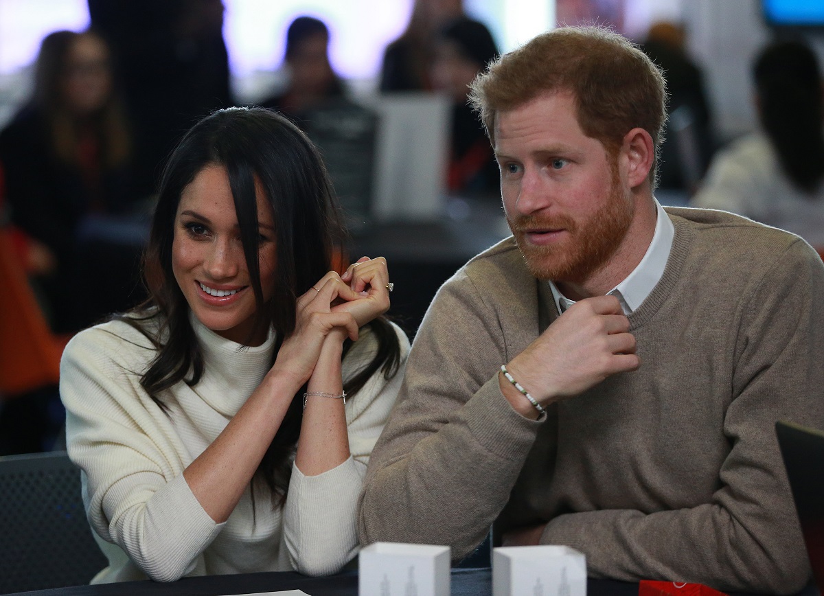 Prince Harry and Meghan Markle, who did not like the duke's friends jokes, at an event in 2018 celebrating International Women's Day