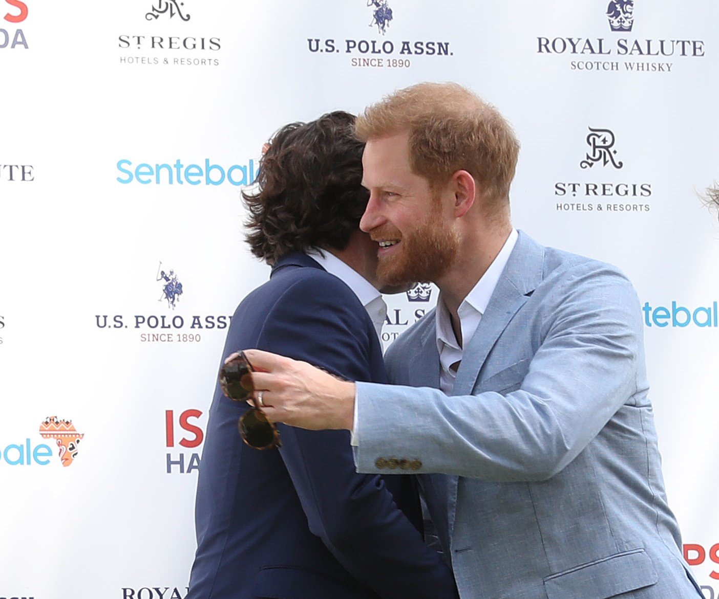 Prince Harry hugging Nacho Figueras, who is being called the duke's 'new brother,' at the Sentebale ISPS Handa Polo Cup
