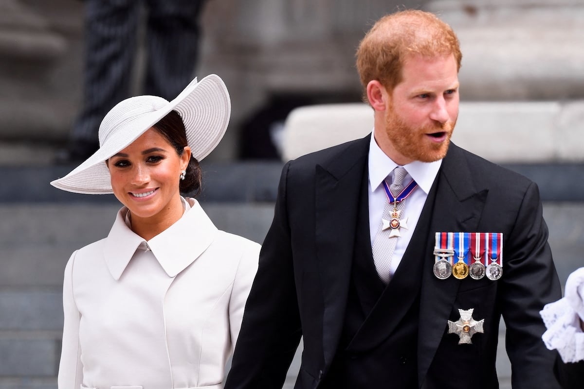 Meghan Markle and Prince Harry smile at an event.