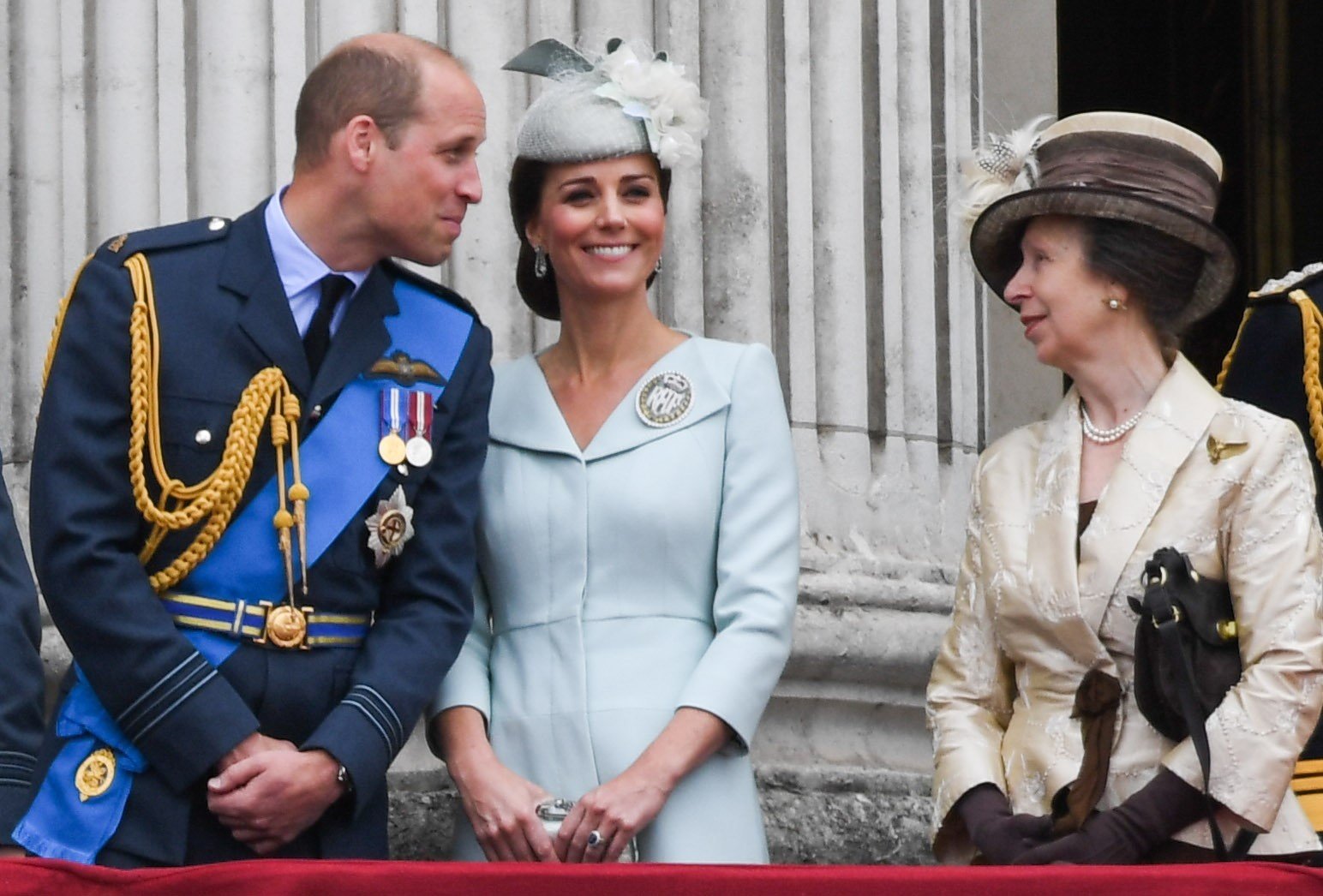Prince William, Kate Middleton, and Princess Anne standing on the balcony of Buckingham Palace