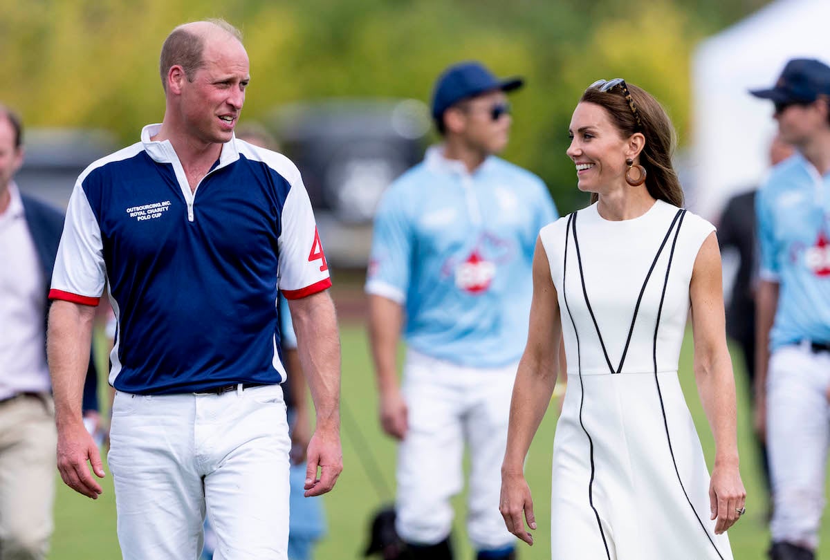 Prince William and Kate Middleton, who a body language expert says hinted at being 'more tactile in private' with polo pda, smile as they walk