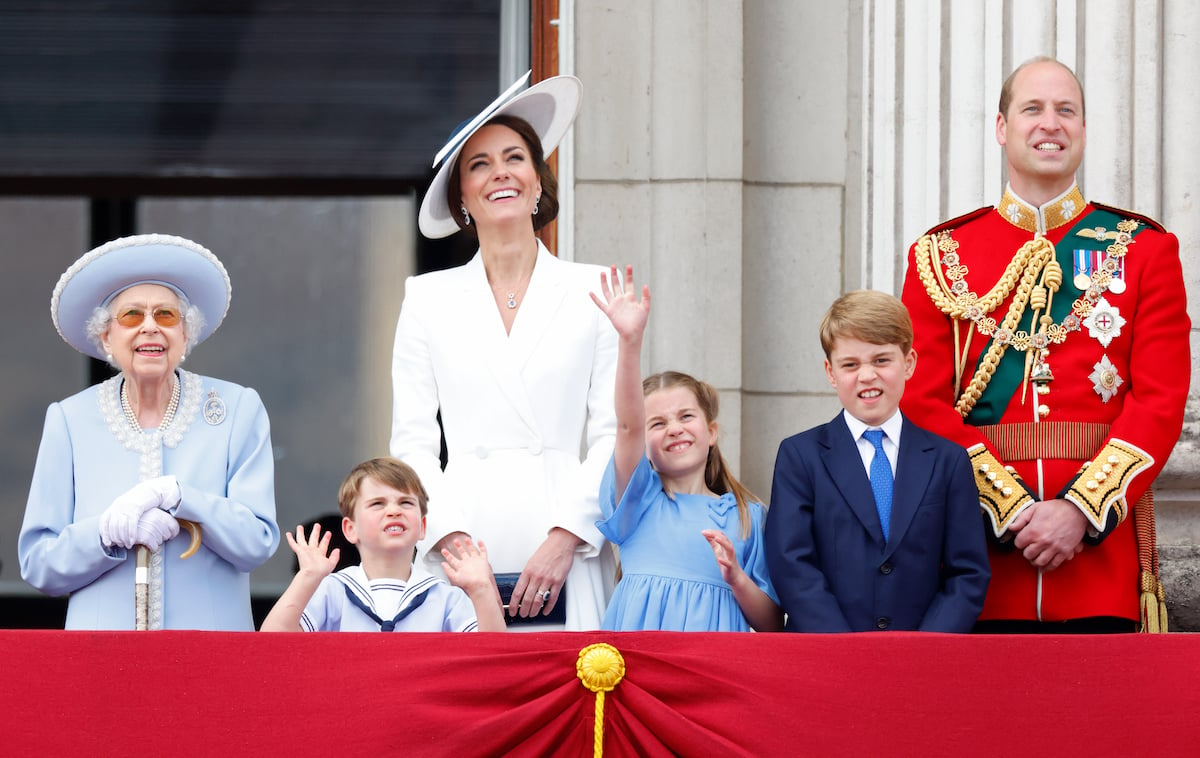 Queen Elizabeth II, who is reportedly unhappy with Prince William and Kate Middleton's helicopter use, stands with the couple and Prince Louis, Princess Charlotte, and Prince George