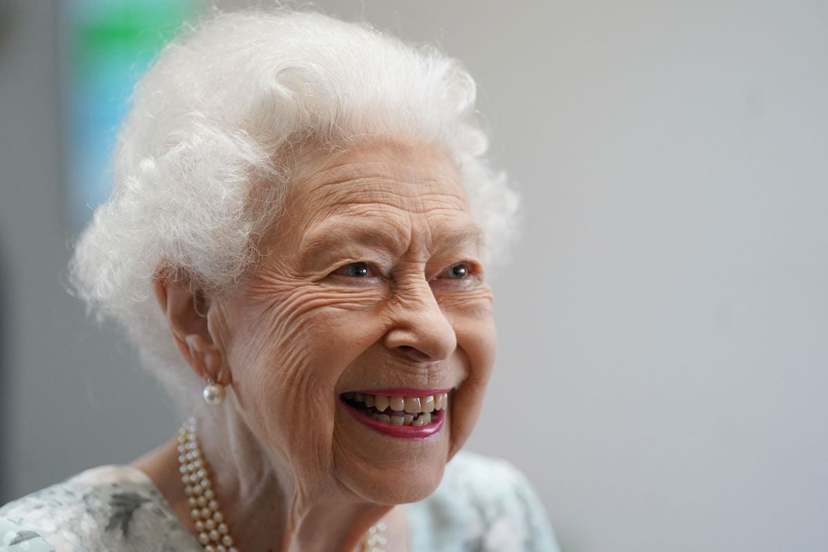 Queen Elizabeth II, who just celebrated her Platinum Jubilee, smiles at an event.