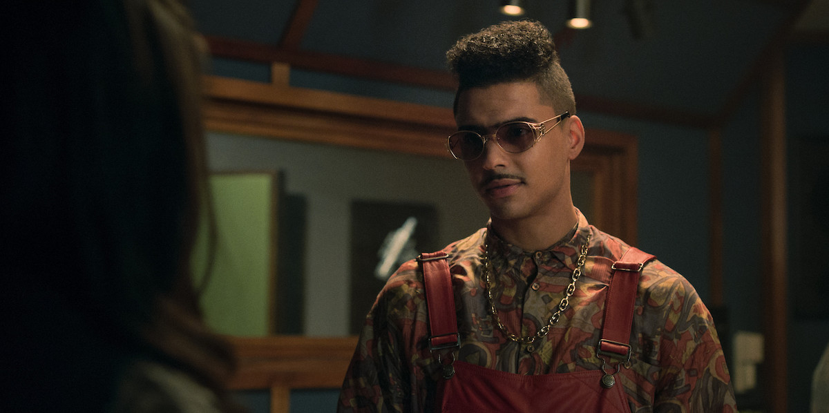 Quincy Brown as Crown Camacho wearing sunglasses and overalls in 'Power Book III: Raising Kanan'