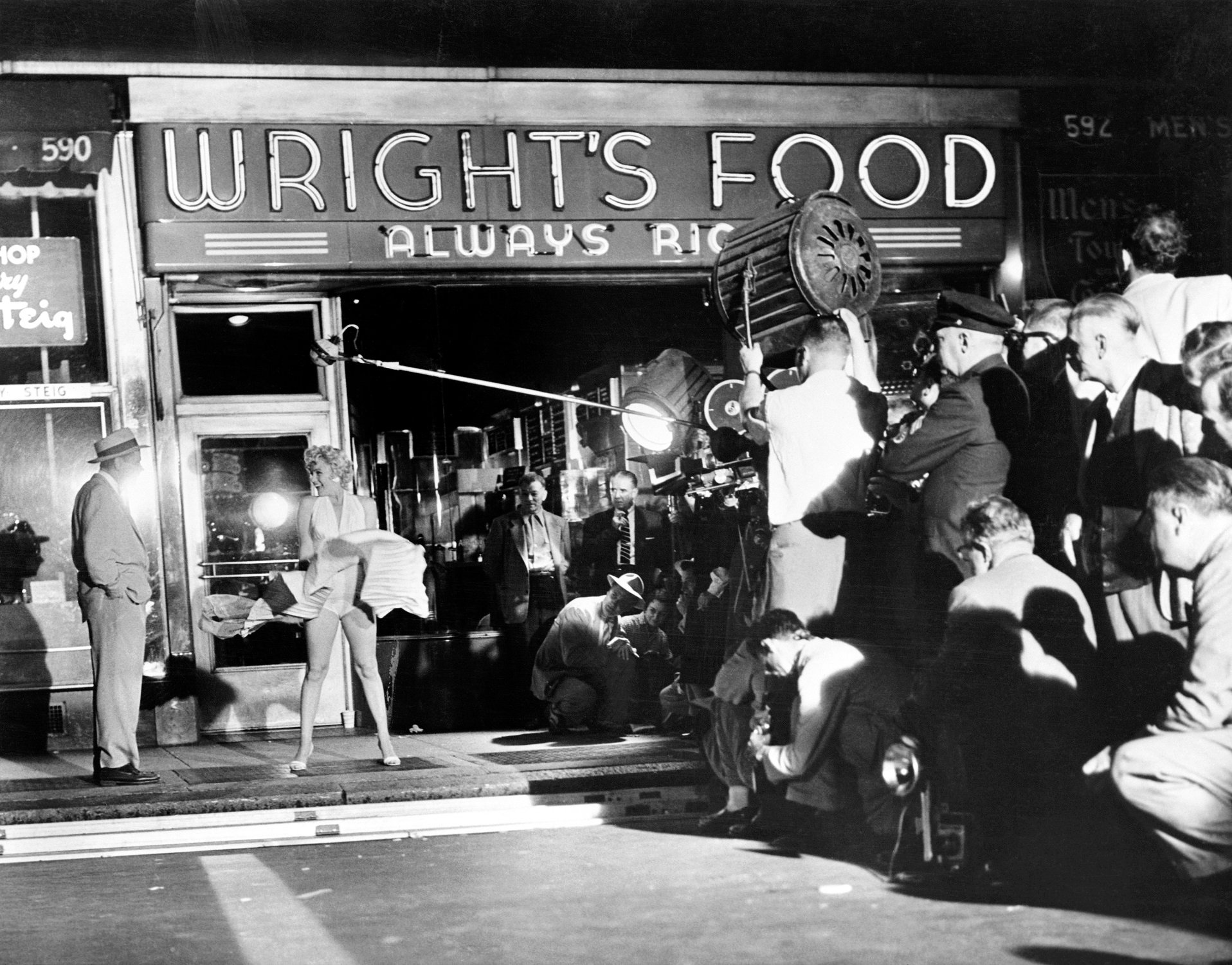 Marilyn Monroe and Tom Ewell film a scene for 'The Seven Year Itch' outside a food store at 51st Street and Lexington Avenue
