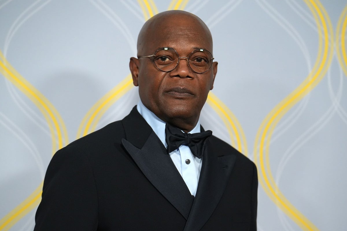 Samuel L. Jackson smirking while wearing a suit.