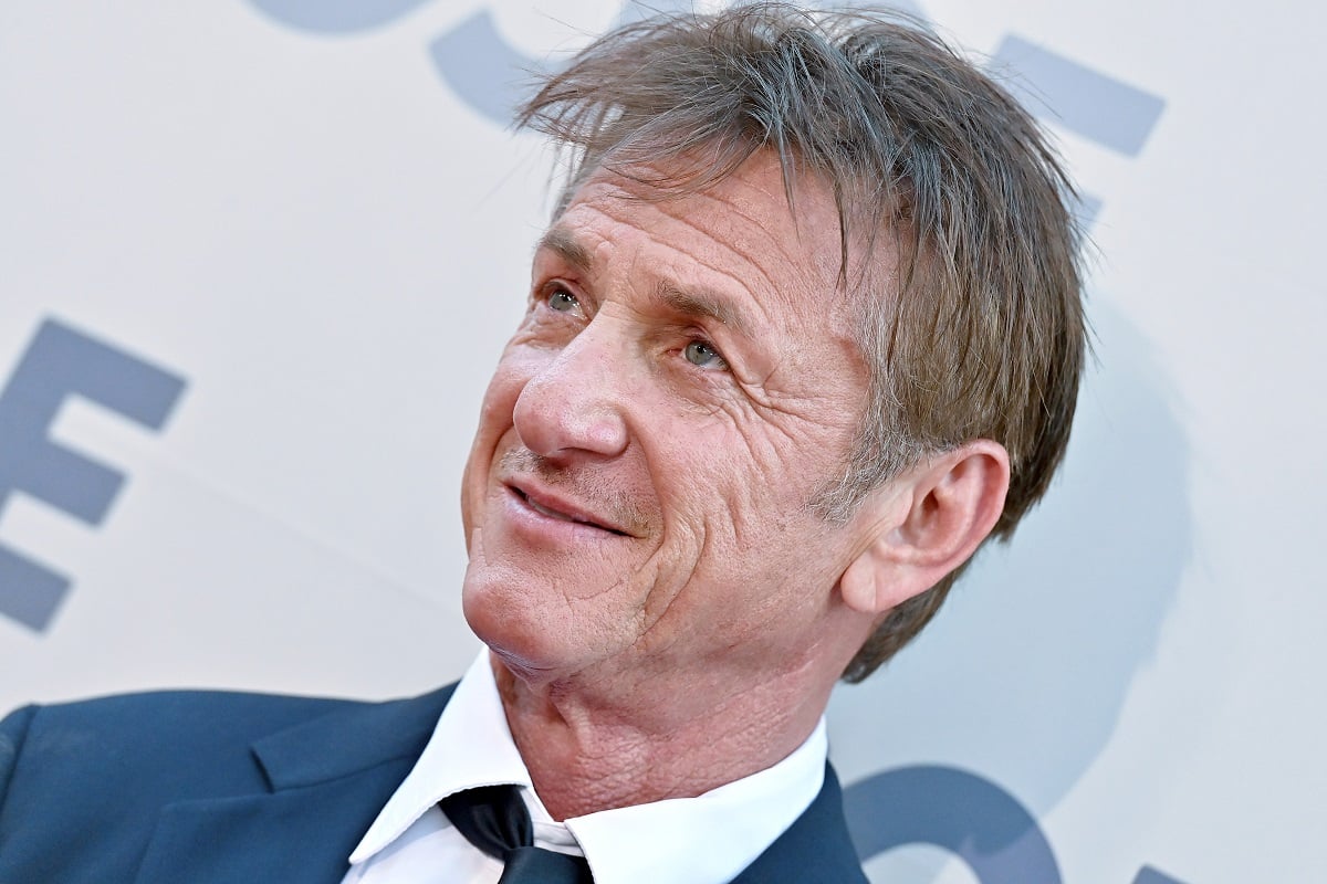 Sean Penn smirking while wearing a suit.