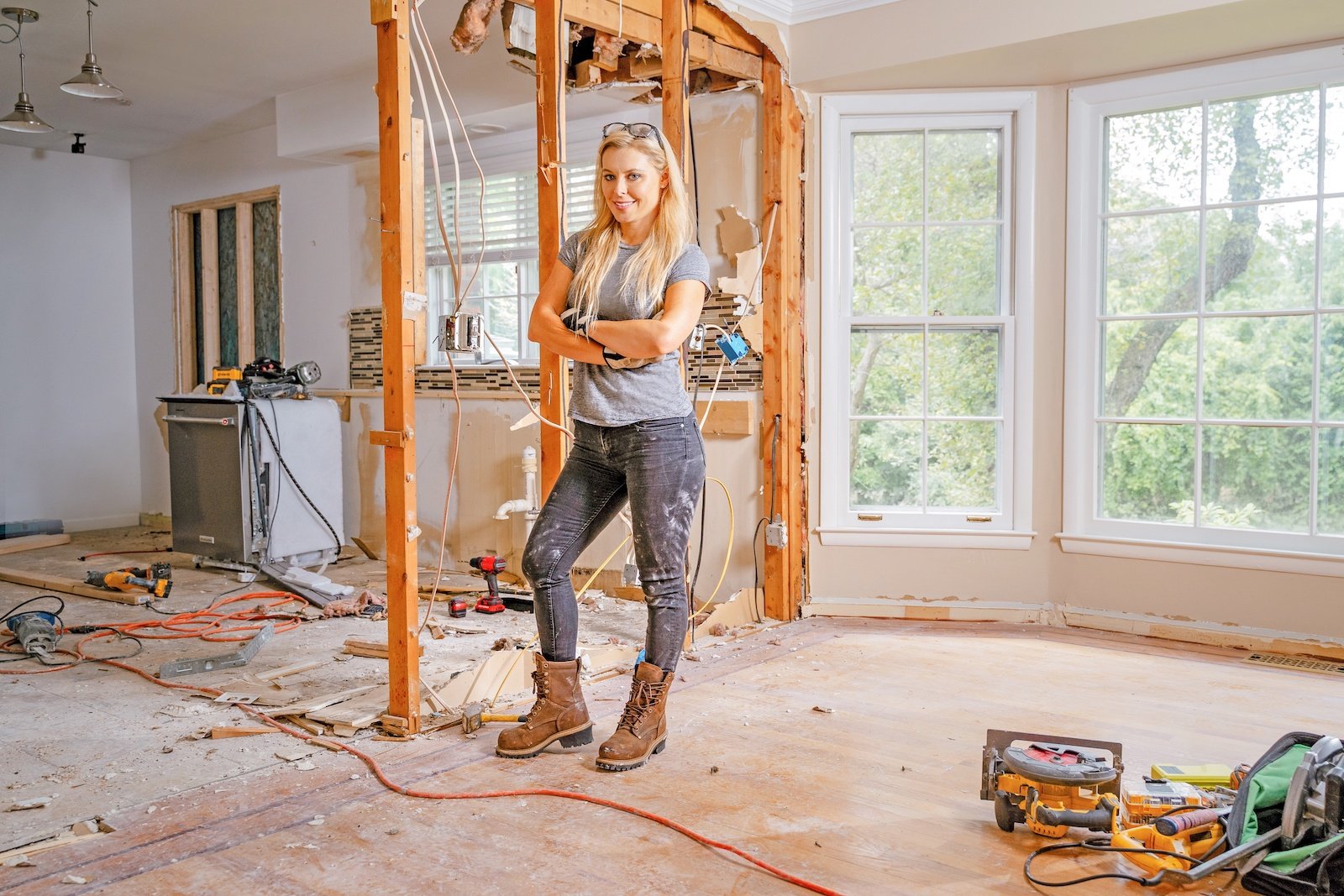 Cristy Lee poses in the middle of a home renovation on 'Steal This House'