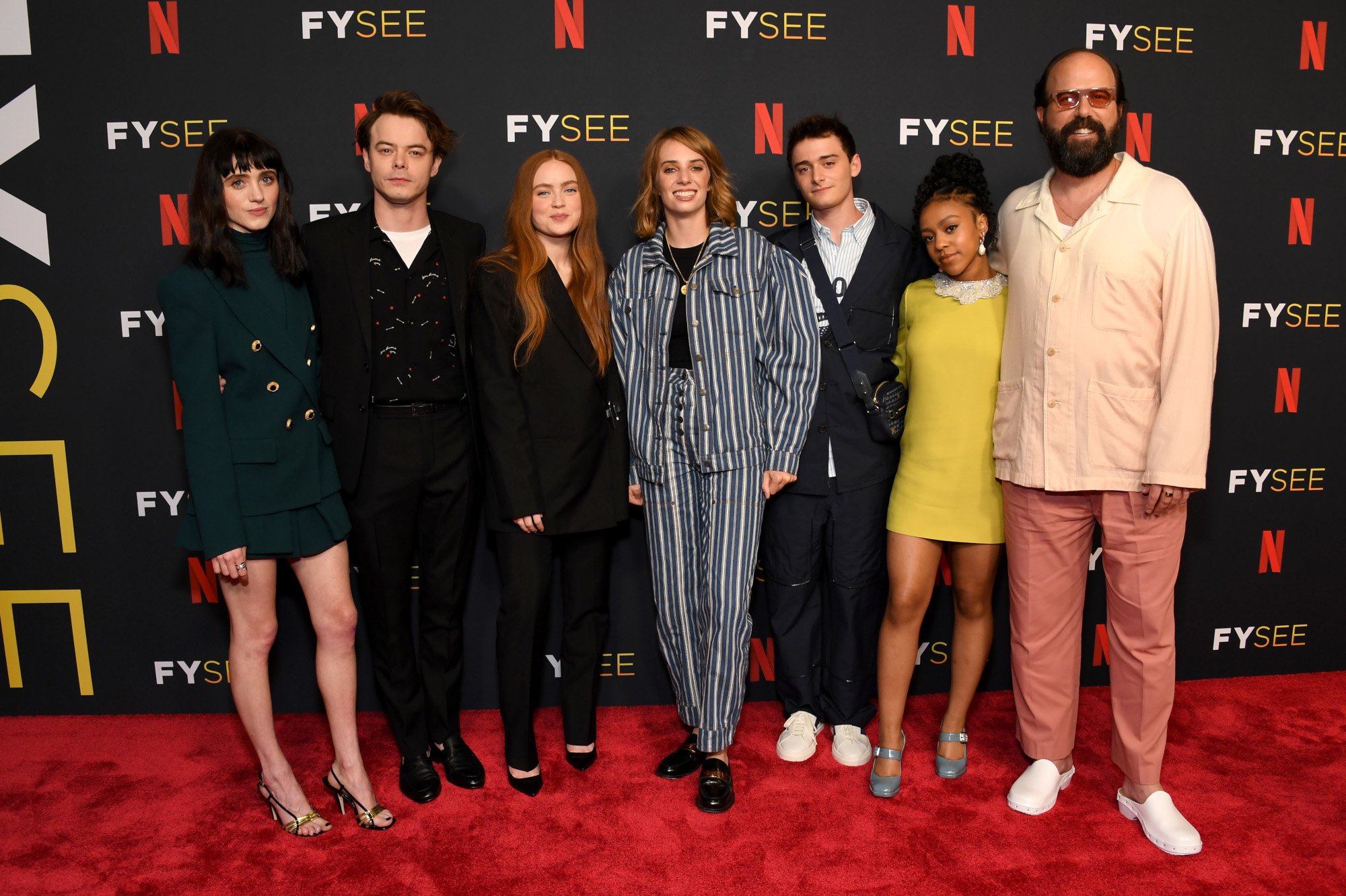 'Stranger Things' cast members Natalia Dyer, Charlie Heaton, Sadie Sink, Maya Hawke, Noah Schnapp, Priah Ferguson and Brett Gelman. They're standing together on the red carpet for a Netflix event promoting the show.