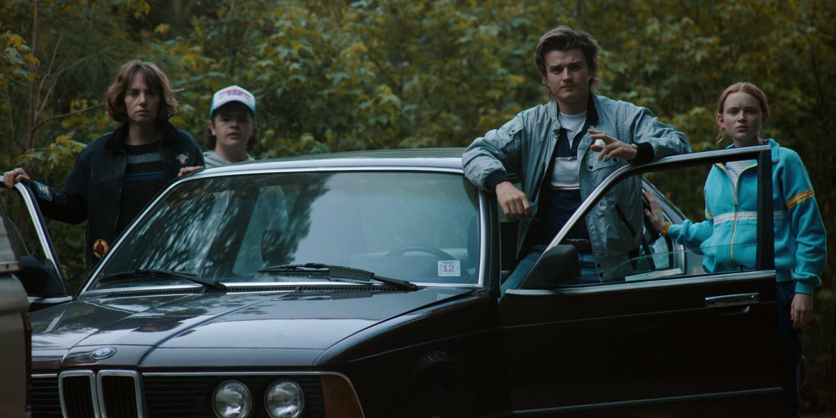 Steve, Robin, Dustin, and Max get out of the car in Stranger Things Season 4. 