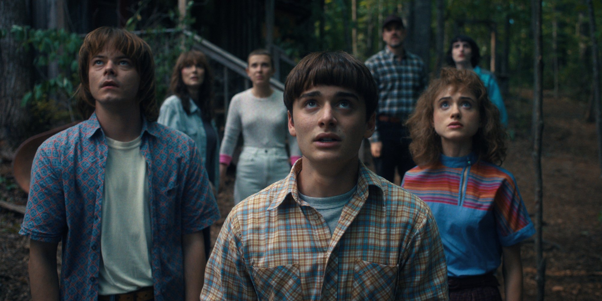 'Stranger Things' Season 4 production still with Noah Schnapp standing in front of his costars wearing a plaid shirt. One 'Stranger Things' Season 5 fan theory suggests Will is back in the spotlight.