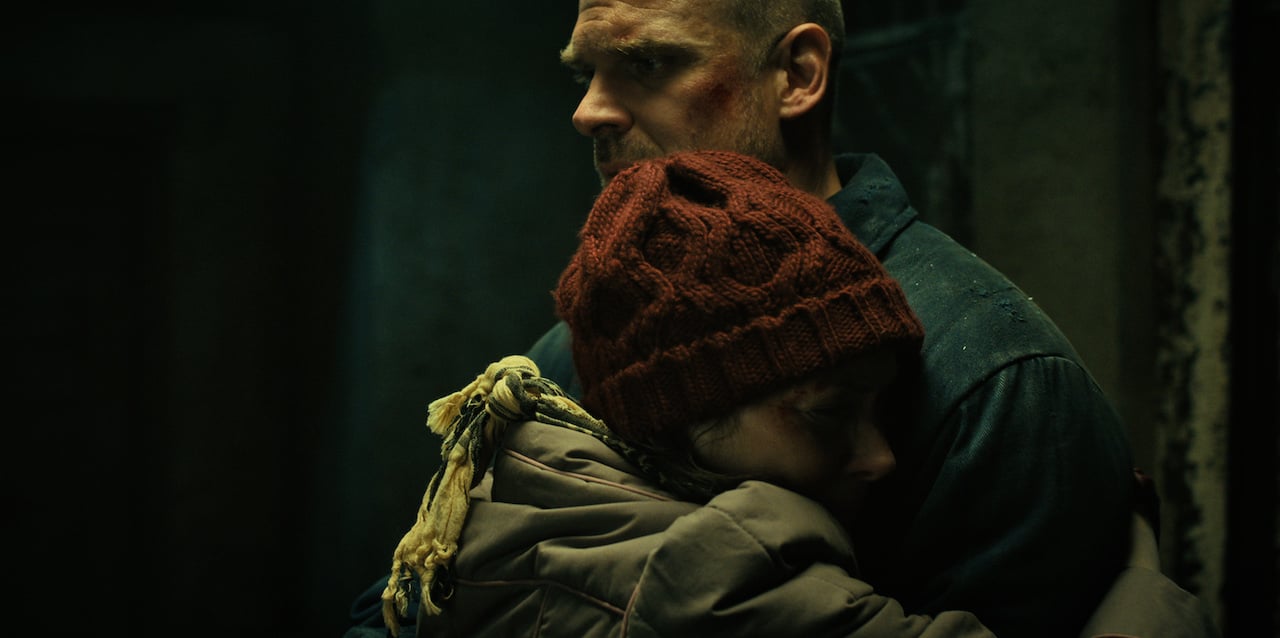 Winona Ryder as Joyce Byers hugs a shocked looking David Harbour as Hopper in 'Stranger Things'
