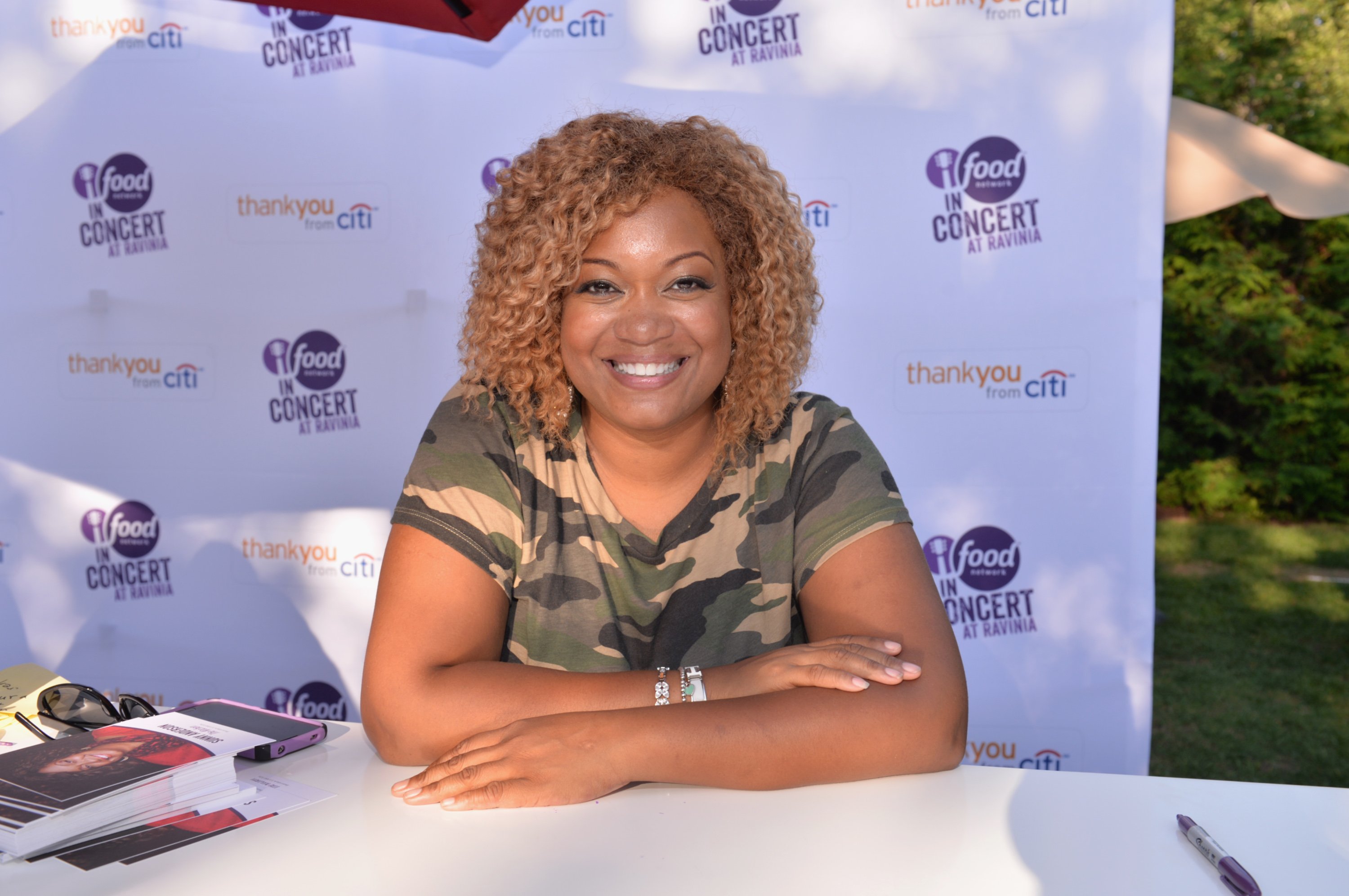 Celebrity chef Sunny Anderson wears a fatigue-style T-shirt in this photograph.