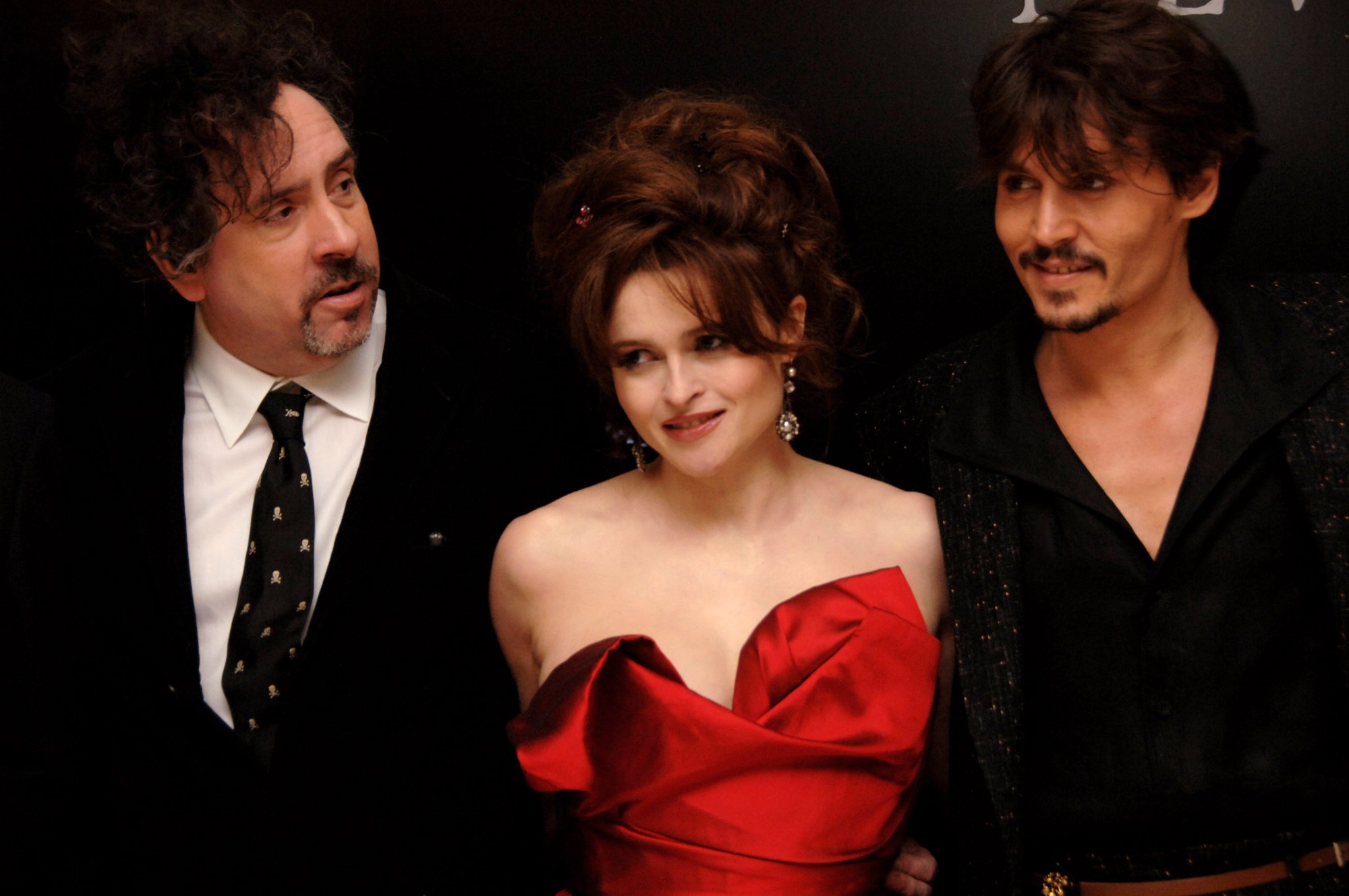 'Sweeney Todd' Tim Burton, Helena Bonham-Carter, and Johnny Depp smiling in formal wear at an event