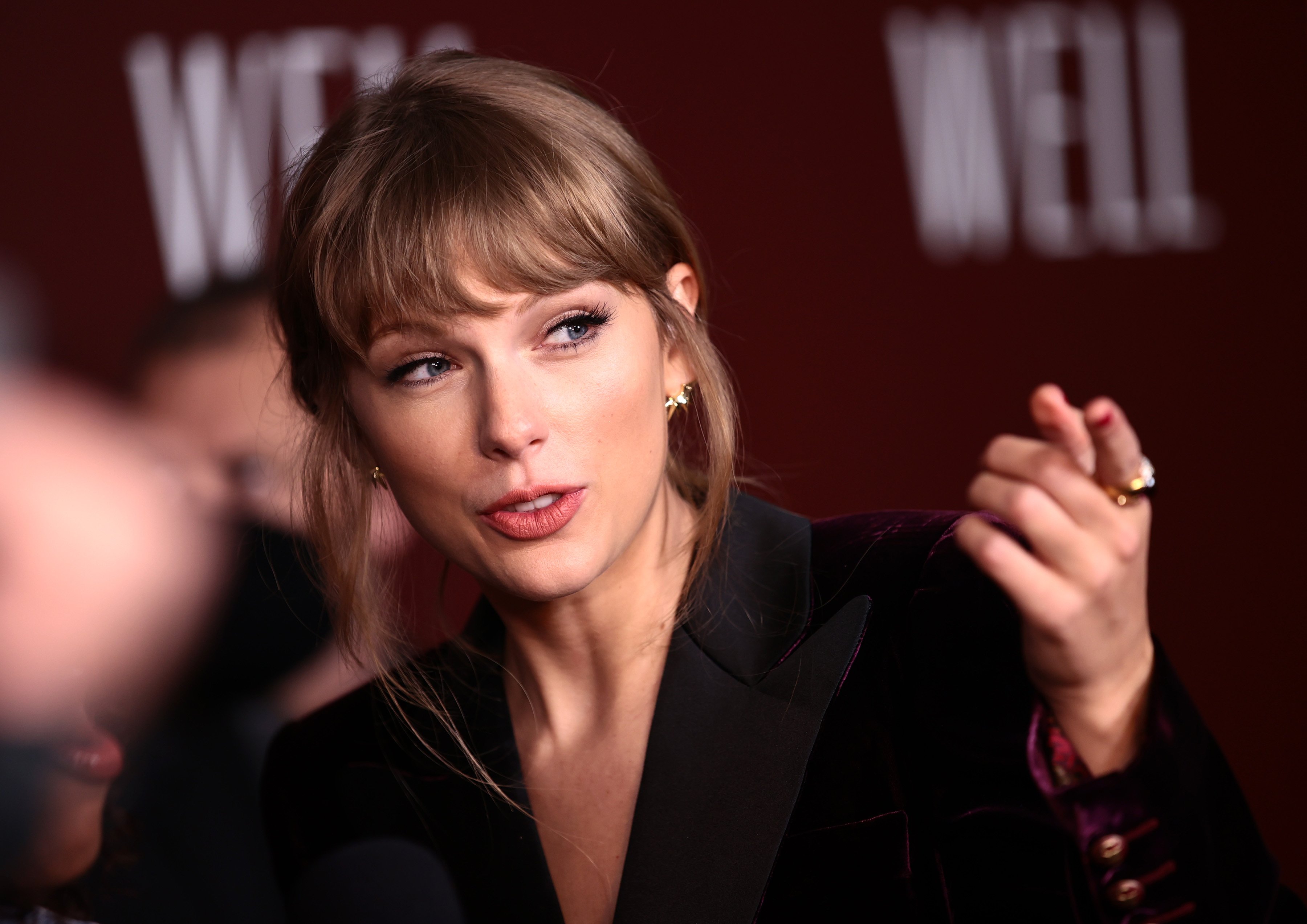 Taylor Swift, whose music helped inspire 'Thor: Love and Thunder,' wears a dark purple velvet suit.