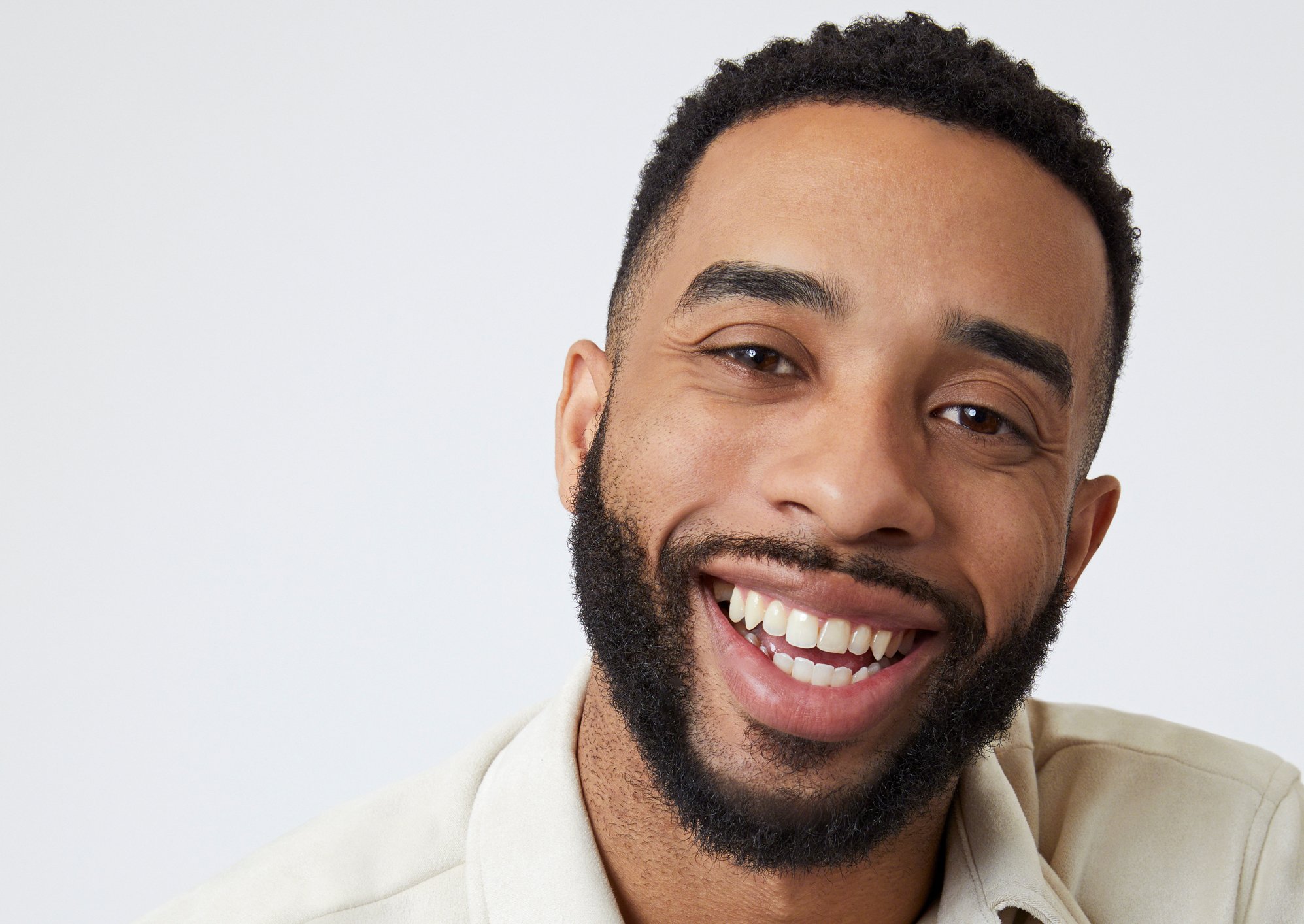 'The Bachelorette' contestant Mario Vassall received the First Impression Rose from Gabby. He's seen here wearing a tan shirt in a promotional image for the show.