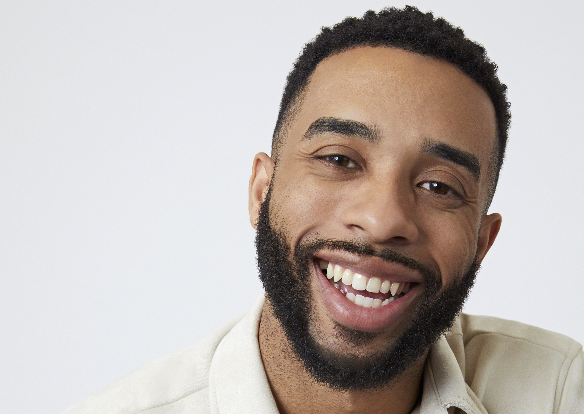 'The Bachelorette' contestant Mario Vassall received the First Impression Rose from Gabby. He's seen here wearing a tan shirt in a promotional image for the show.