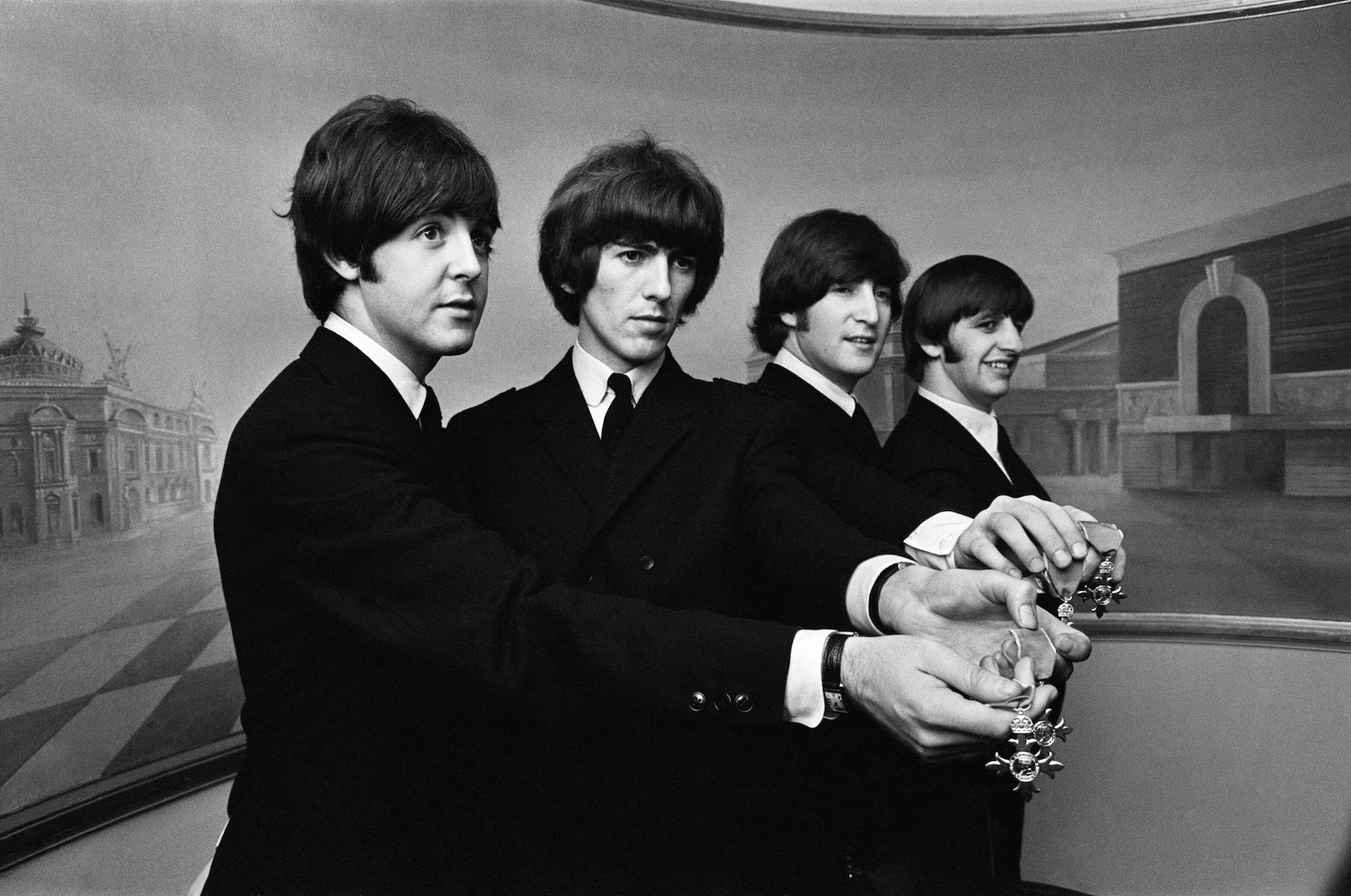The Beatles show off their MBE medals after the royal investiture