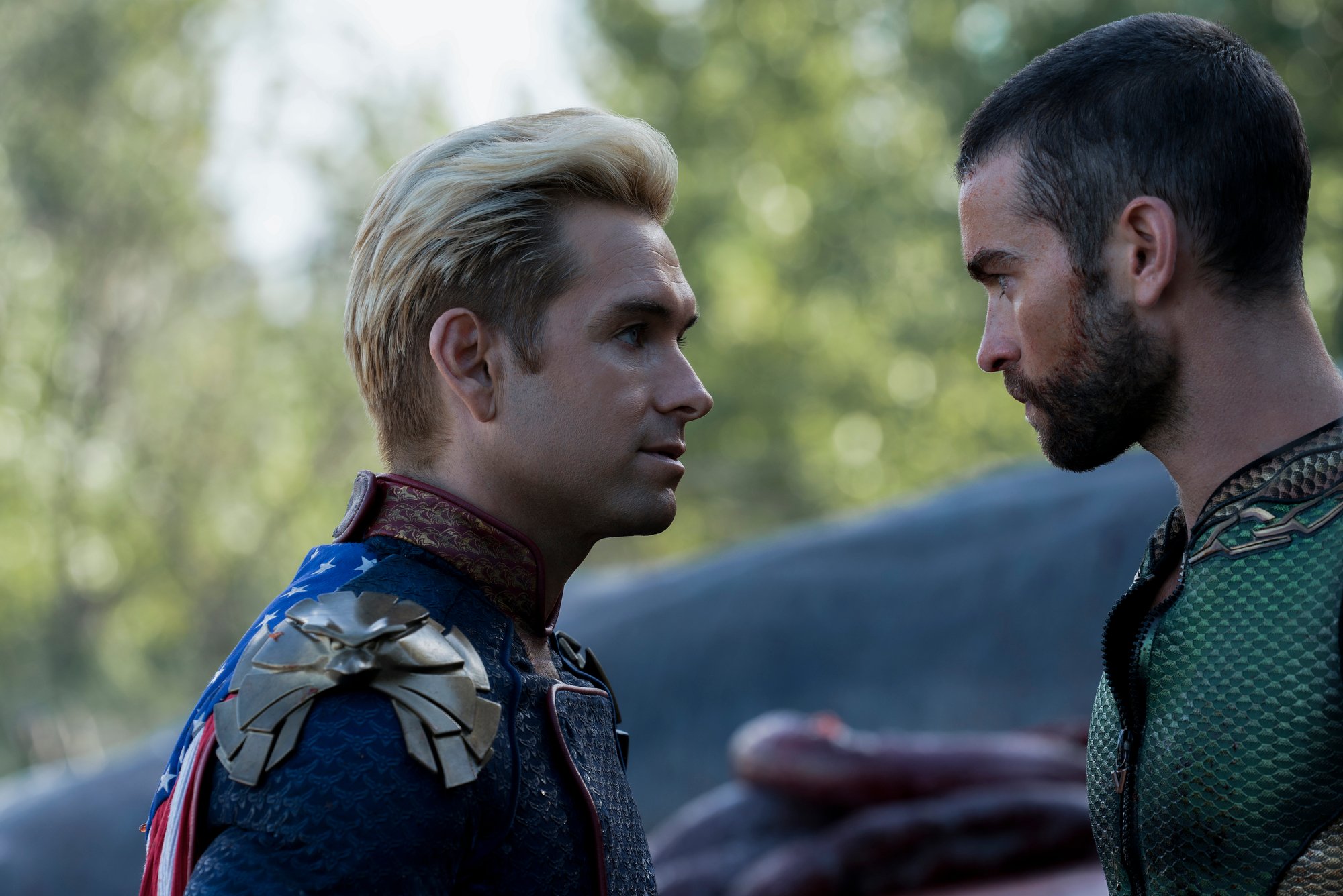 'The Boys' Antony Starr as Homelander and Chace Crawford as The Deep wearing their superhero costumes looking serious at each other