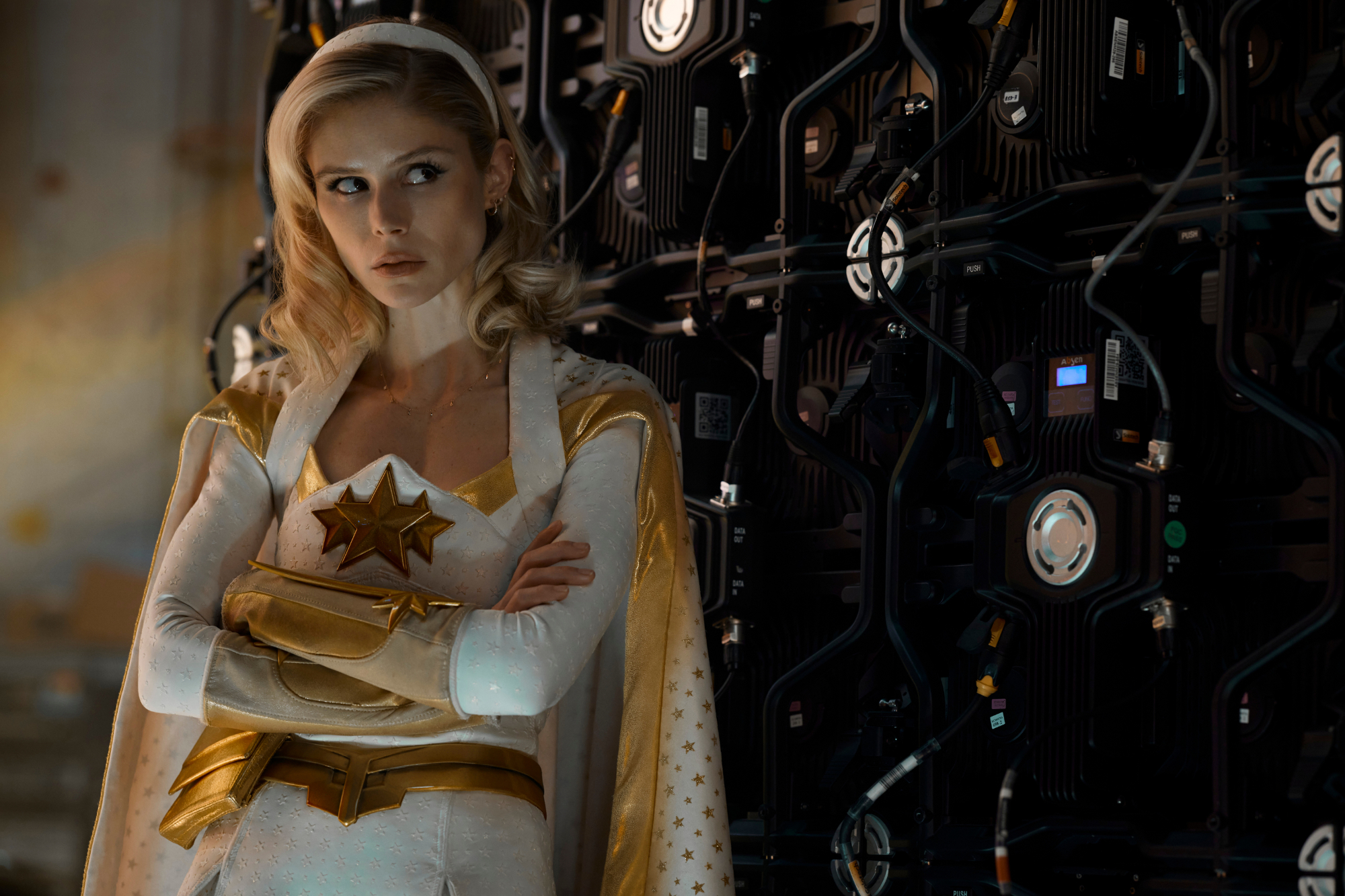 'The Boys' Season 3 Erin Moriarty as Starlight wearing her gold and white costume with her arms crossed