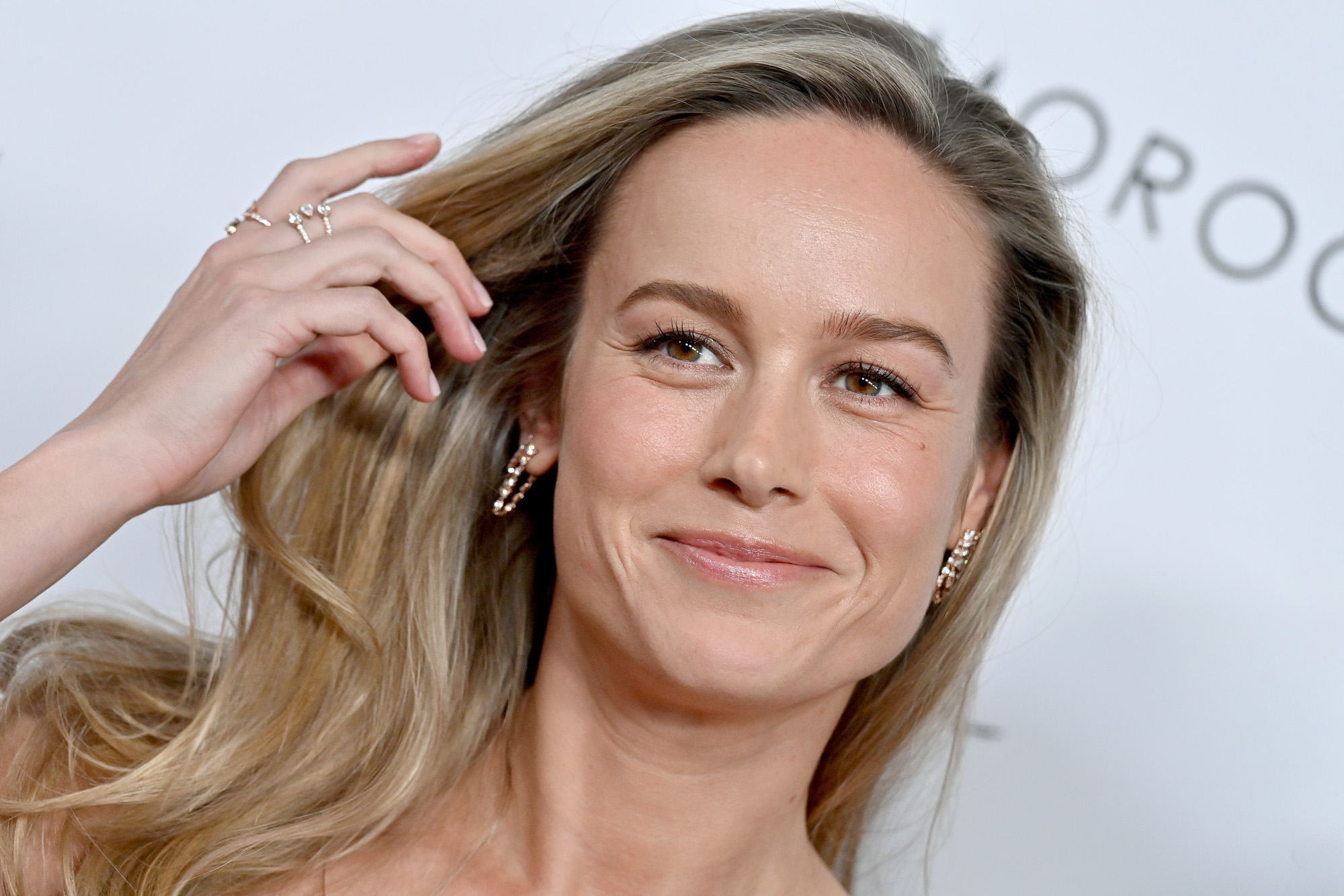Brie Larson, star of 'The Marvels,' which has a 2023 release date. In the photo, her blonde hair is down and she's smiling.