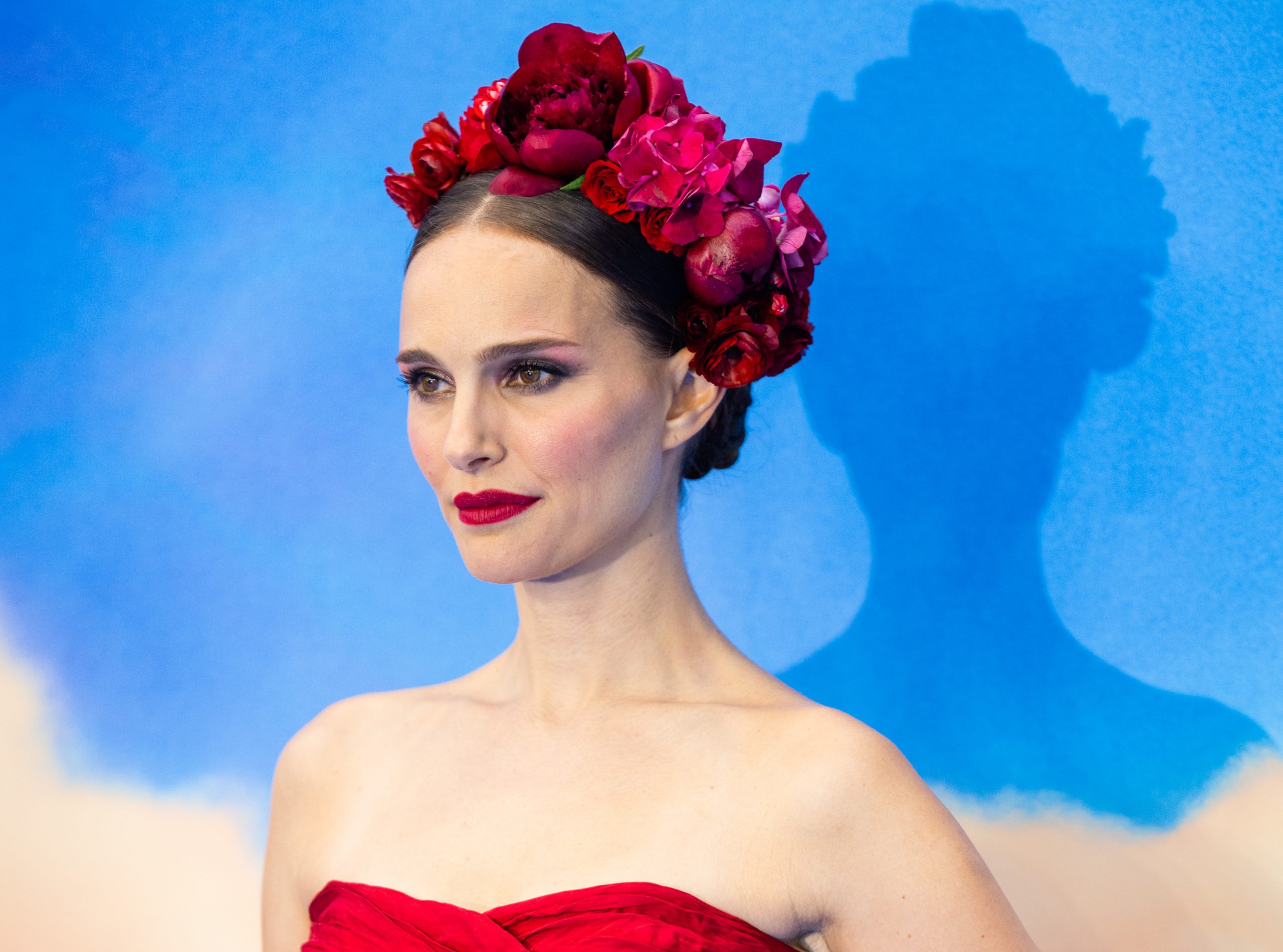 Natalie Portman, who stars in 'Thor: Love and Thunder,' wears a red strapless dress and red rose crown.