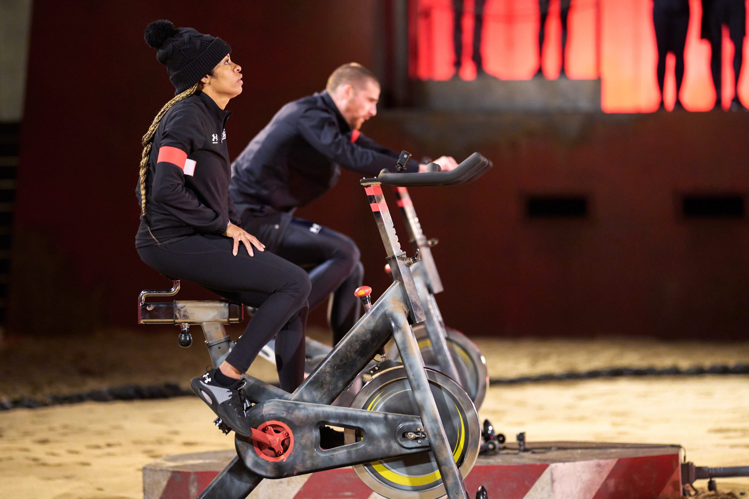 Tiffany Mitchell and Cashel Barnett pedaling stationary bikes during 'The Challenge: USA'