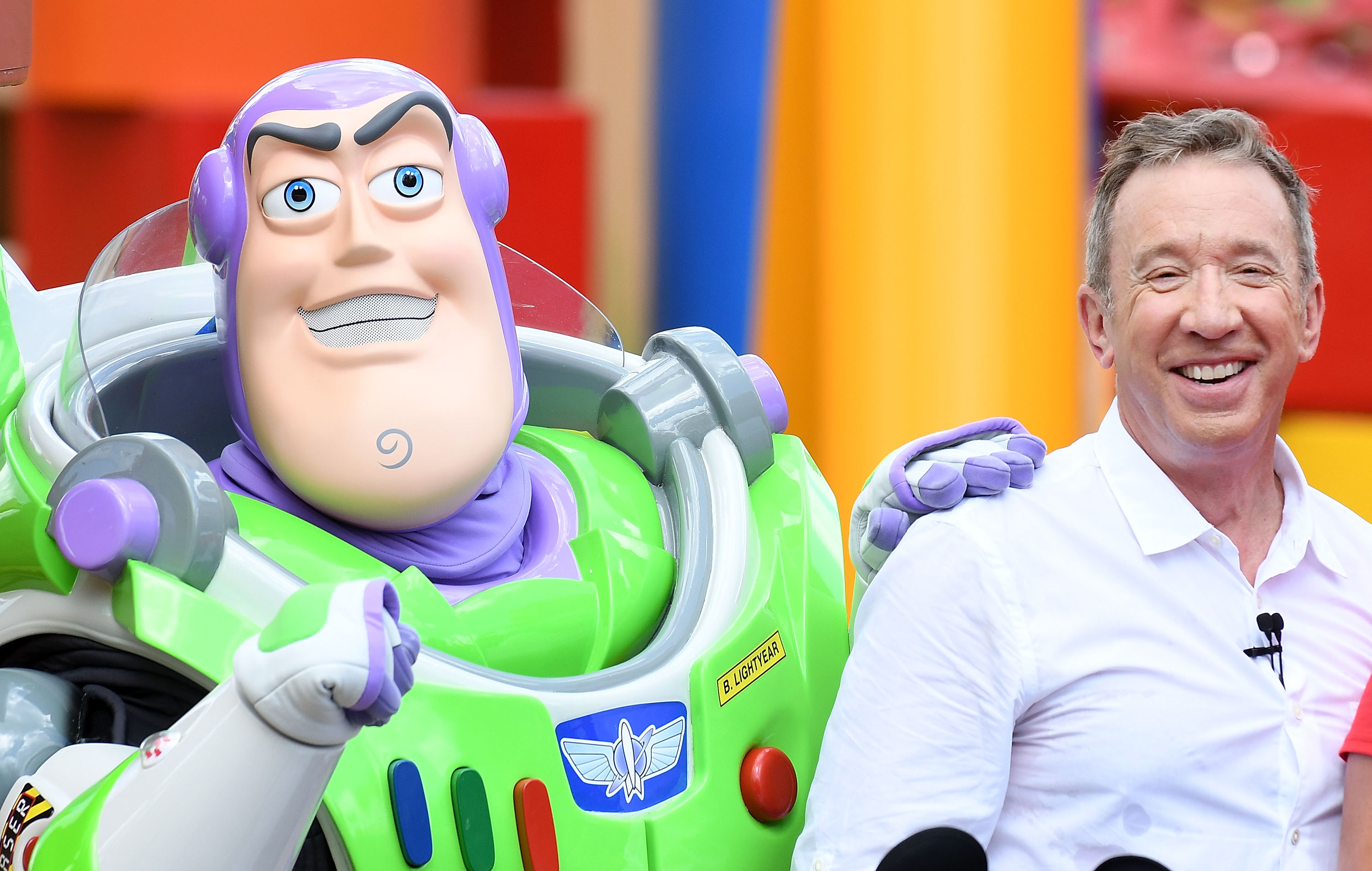Toy Story actor Tim Allen poses with Buzz Lightyear at Toy Story Land at Disney's Hollywood Studios in Florida