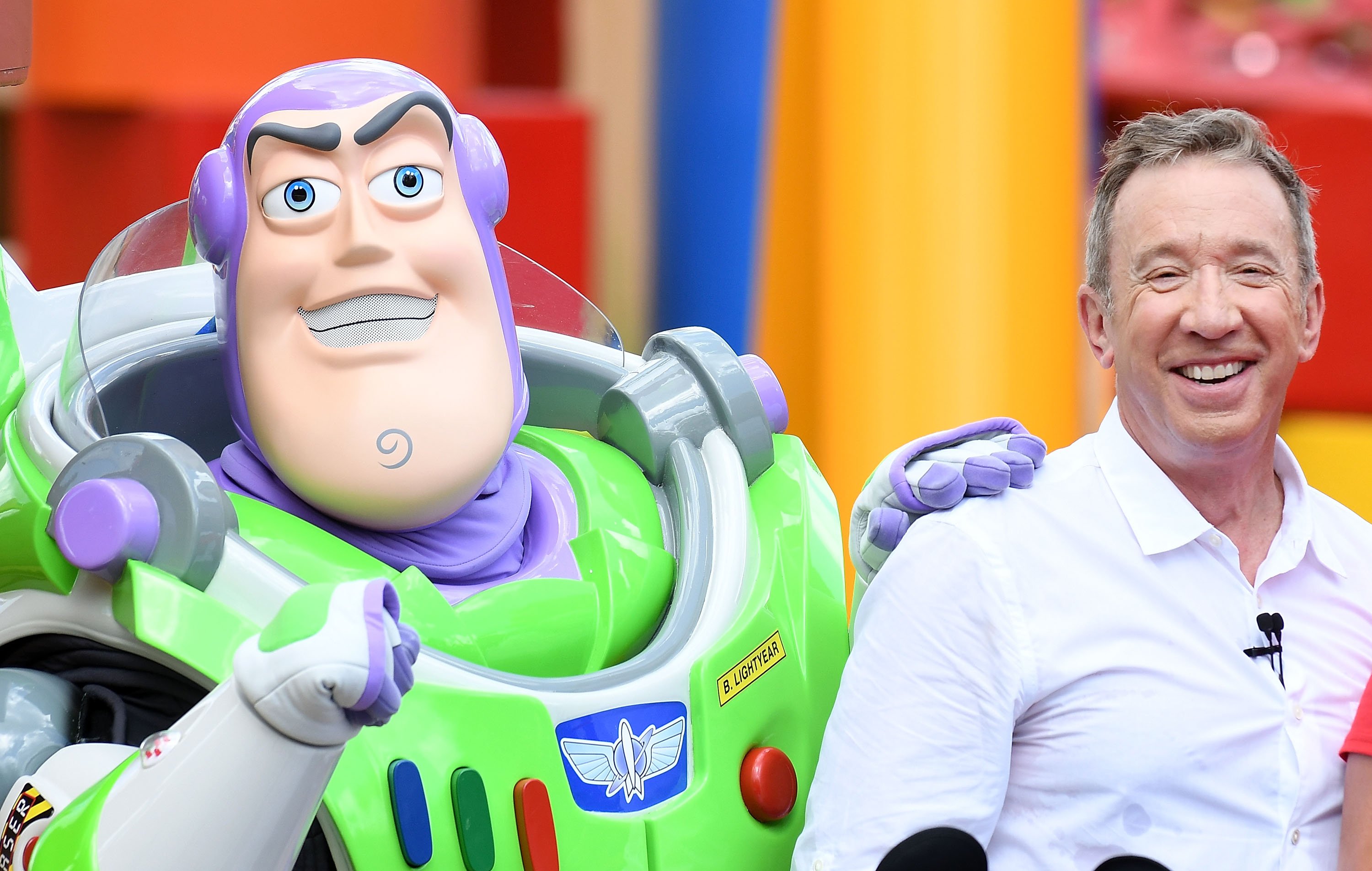 Toy Story actor Tim Allen poses with Buzz Lightyear at Toy Story Land at Disney's Hollywood Studios in Florida