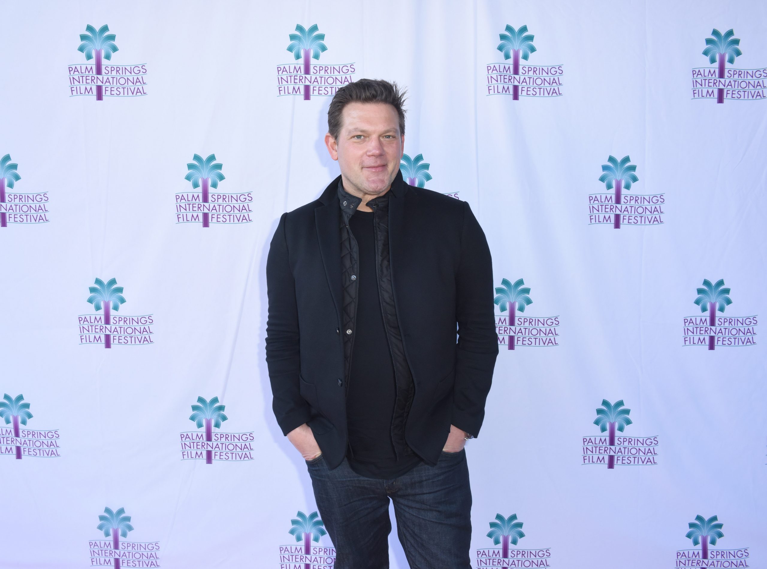 Food Network star Tyler Florence wears a dark-colored jacket and shirt in this photograph.