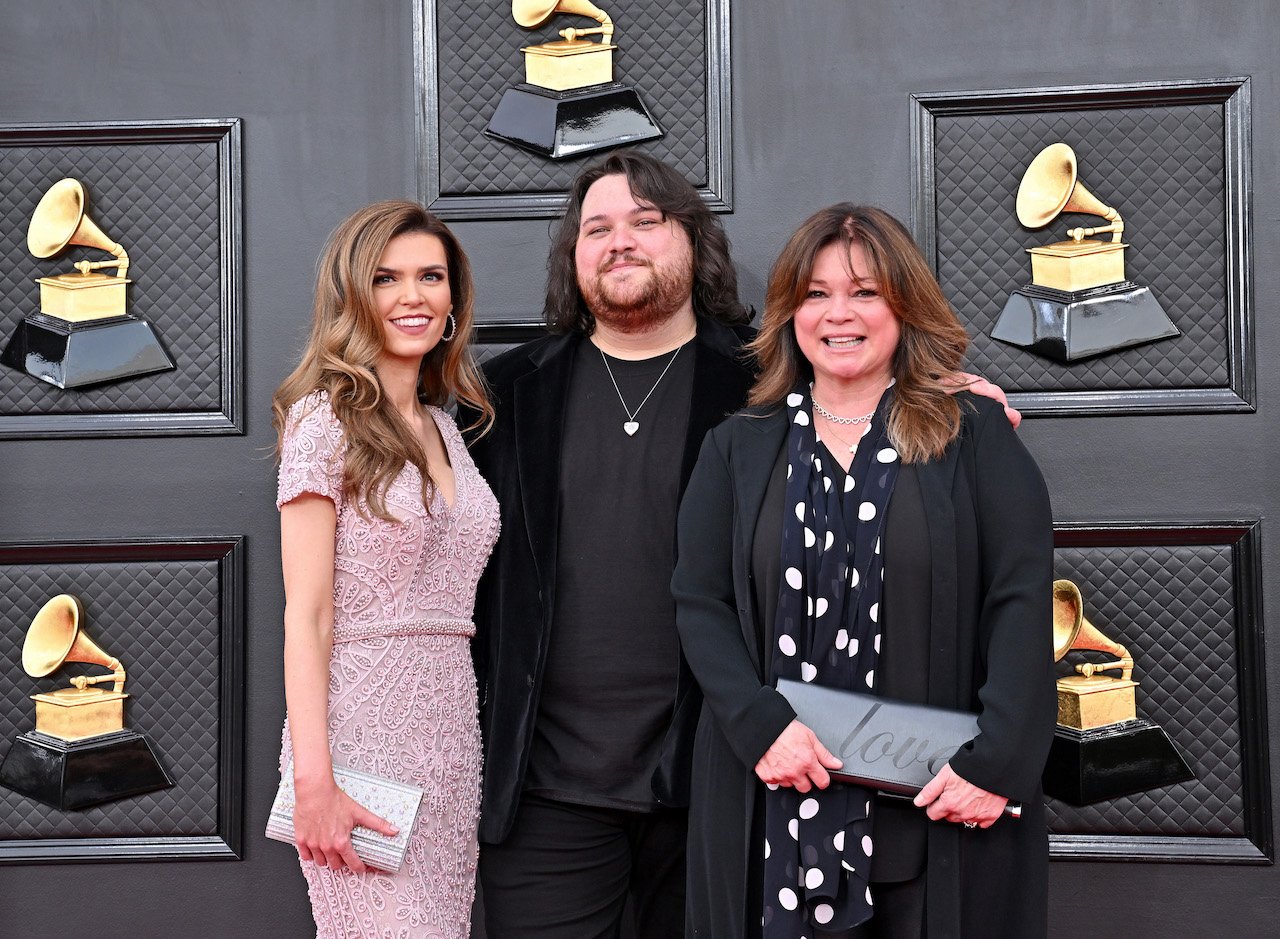 Recently engaged couple Andraia Allsop and Wolfgang Van Halen pose with his mother Valerie Bertinelli
