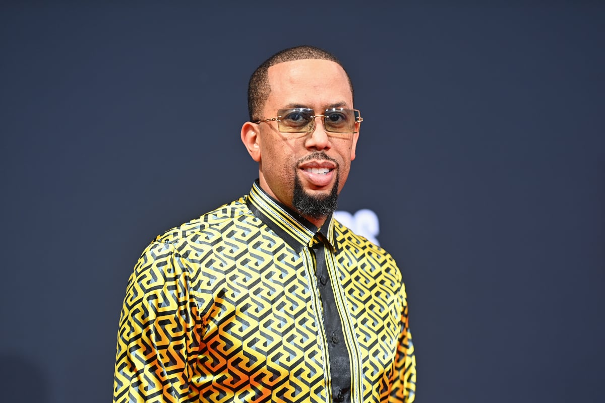 Affion Crockett portrays Richie suck in What We Do in the Shadows. Crockett wears a yellow jacket and sunglasses.