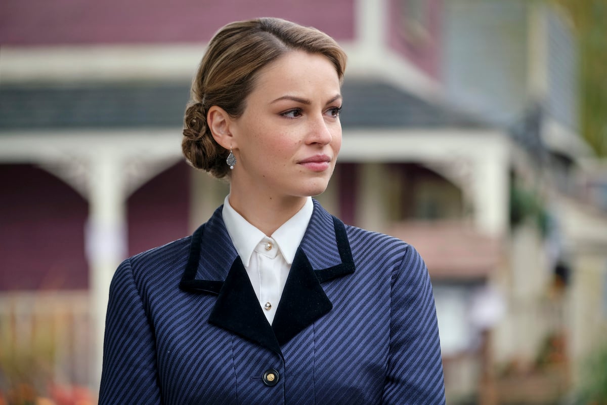 Kayla Wallace as Fiona Miller, wearing a blue jacket and white shirt, in 'When Calls the Heart' Season 9