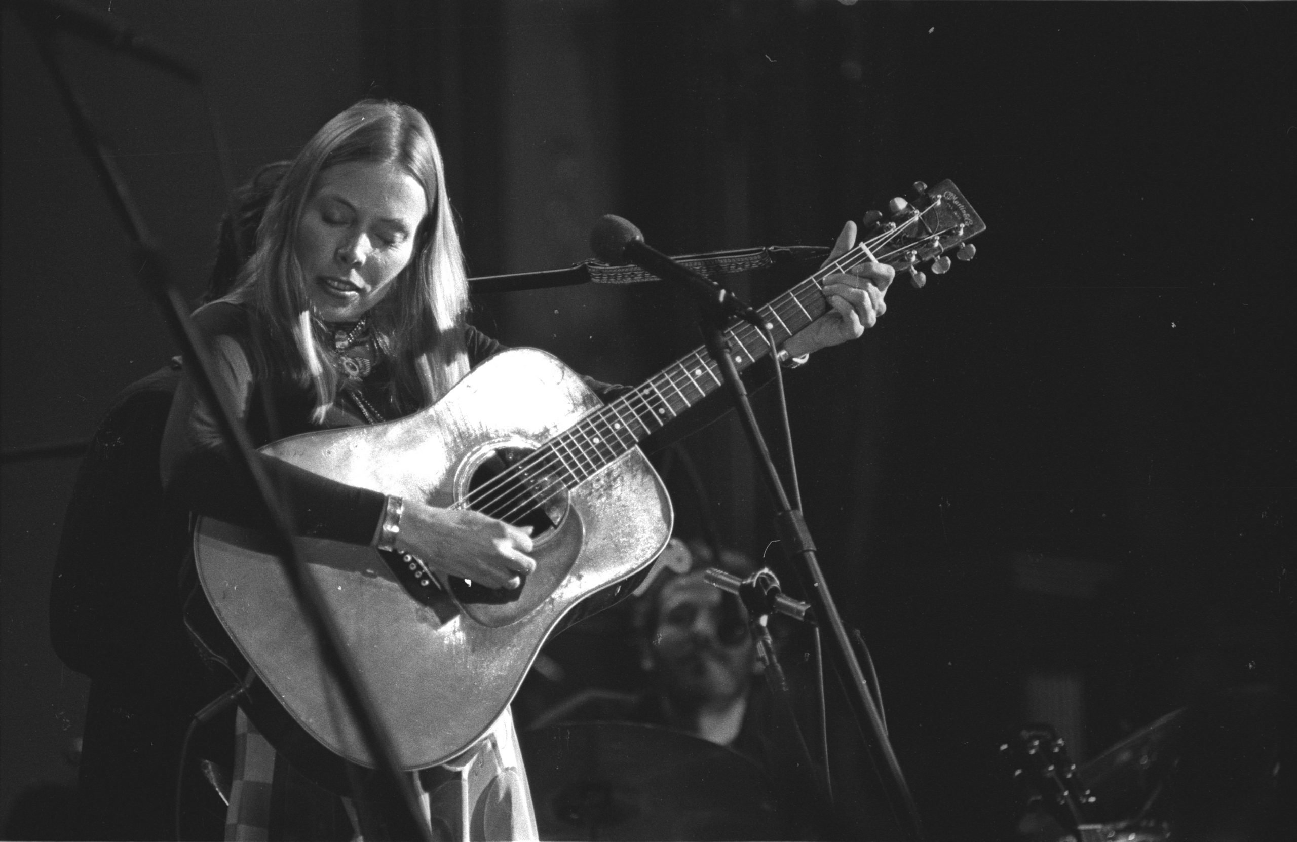 "Both Sides, Now" singer Joni Mitchell holding a guitar