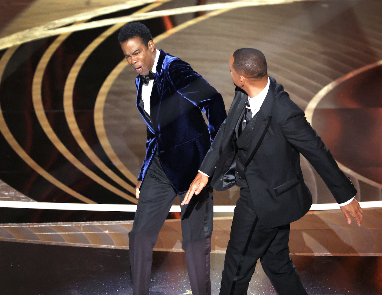 Will Smith (right) and Chris Rock moments after Smith slapped Rock at the 2022 Academy Awards. Smith finally apologized to Rock for the Oscars slap with a July 2022 video on his YouTube channel.