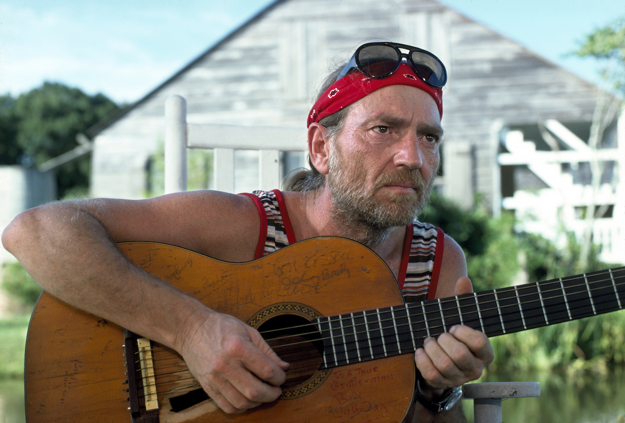 Willie Nelson, pictured playing his guitar, could cause fights without flirting