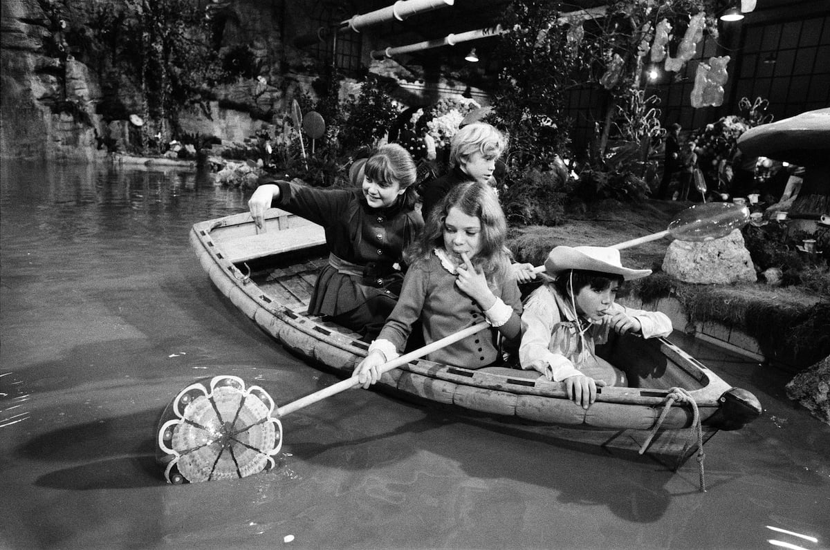 'Willy Wonka & the Chocolate Factory' scene with child actors in a boat in the chocolate river, in black and white