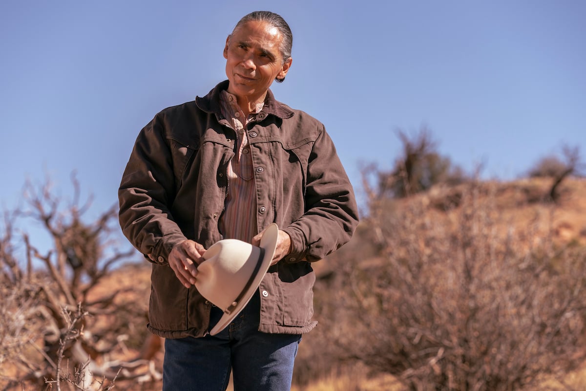 Zahn McClarnon as Joe Leaphorn holding his hat in the 'Dark Winds' Season 1 finale