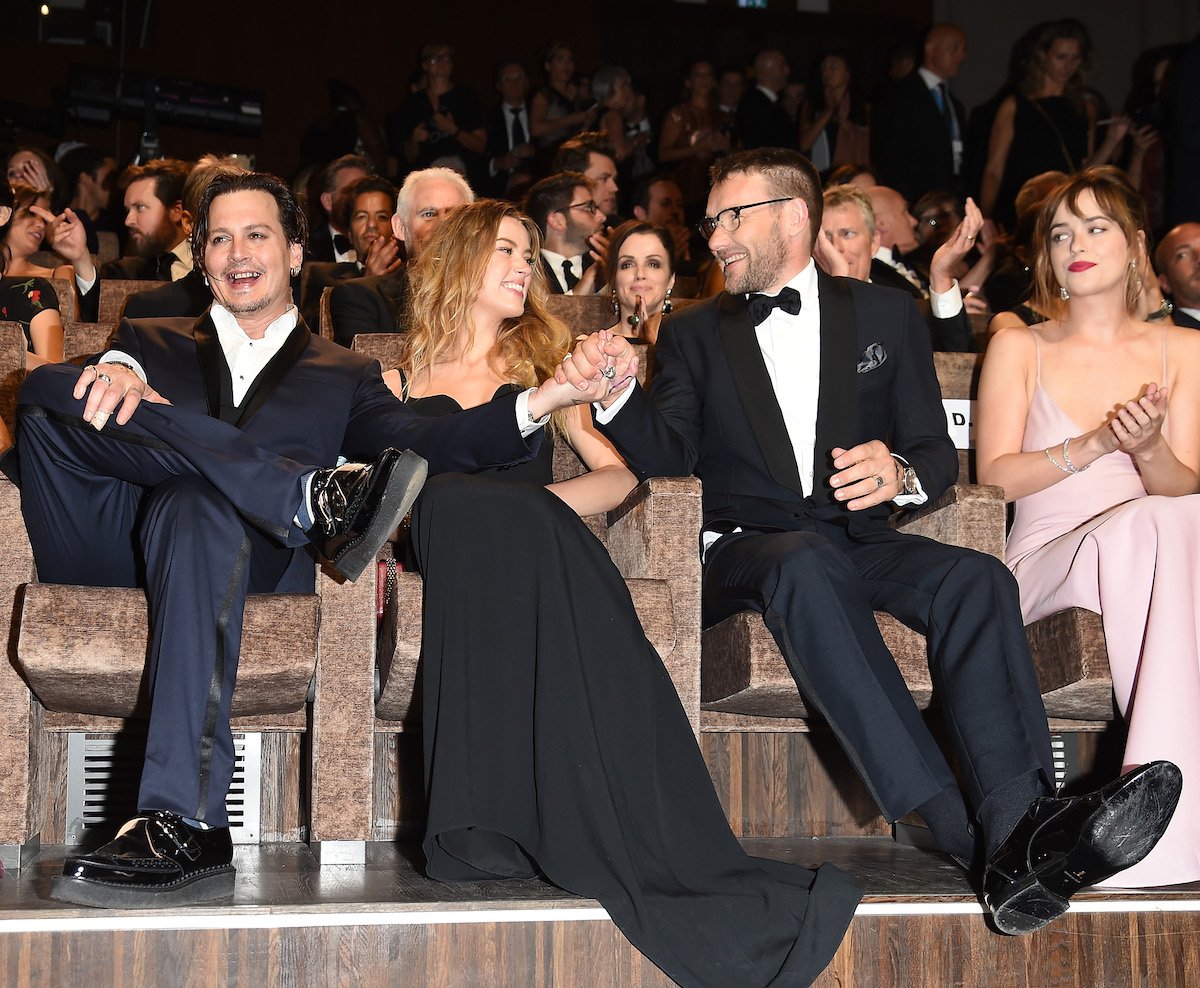 Johnny Depp, Amber Heard, Joel Edgerton, and Dakota Johnson seated in a row