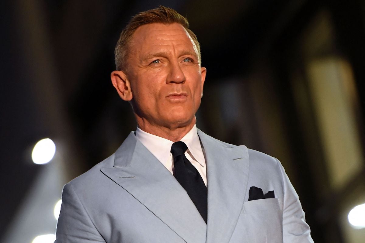 headshot of James Bond actor Daniel Craig in a light gray suit