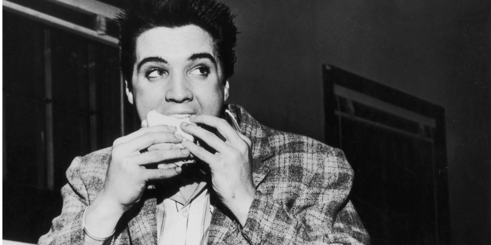 Elvis Presley eating a sandwich minus the one vegetable he hated.