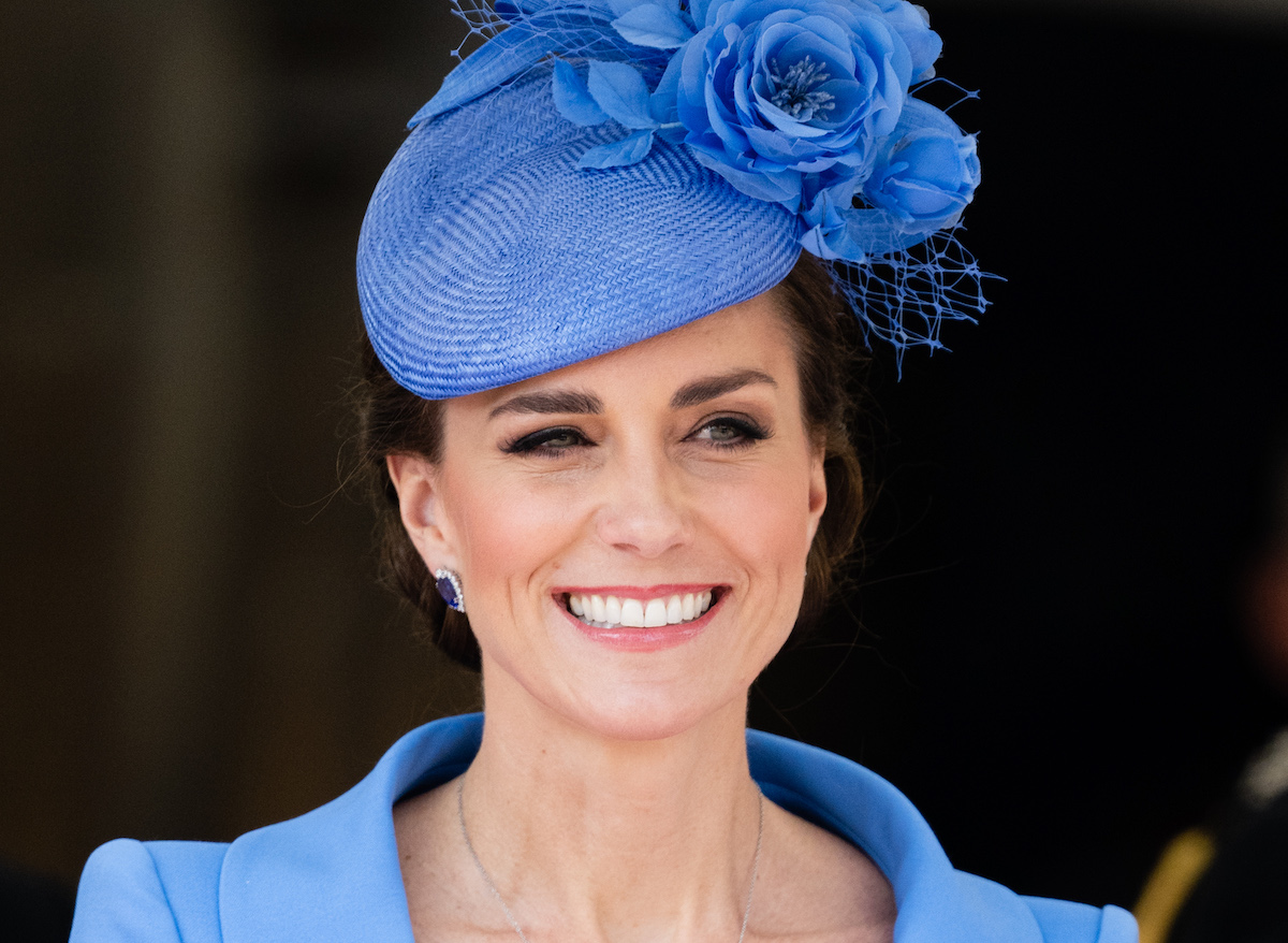 Kate Middleton — Catherine, Duchess of Cambridge — smiling and wearing a blue hat