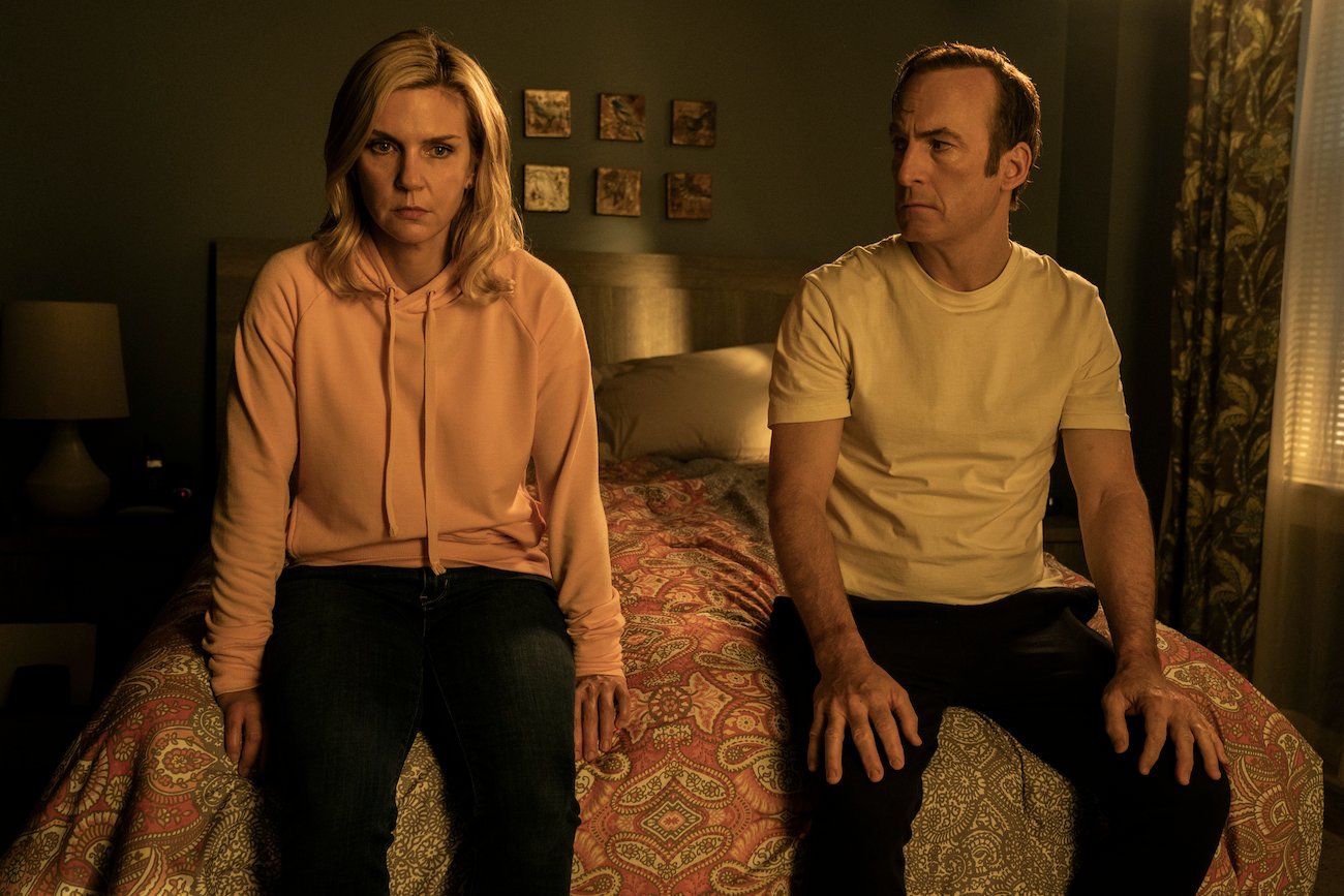 Kim Wexler (Rhea Seehorn) sits next to Saul Goodman (Bob Odenkirk) on the bed of their apartment in season 6 of 'Better Call Saul'